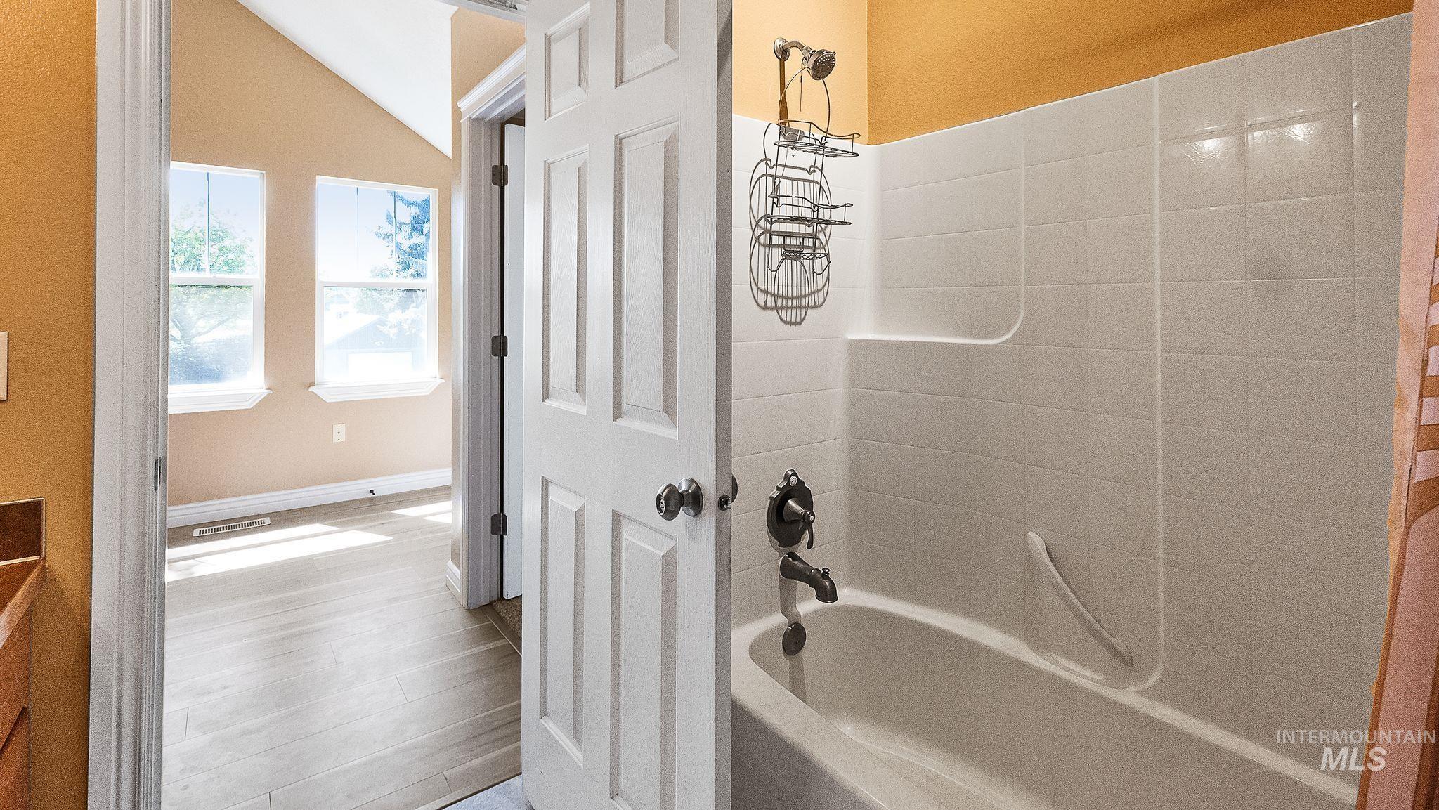 Upstairs bathroom features, vanity and tub/shower.