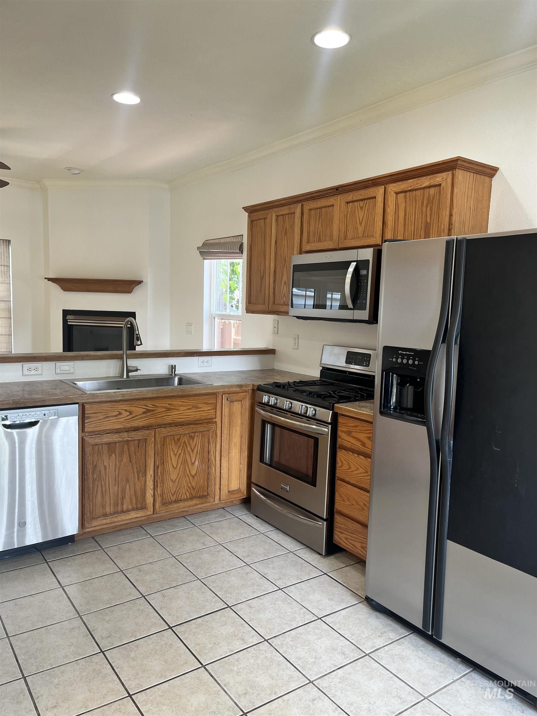Kitchen includes stainless appliances.