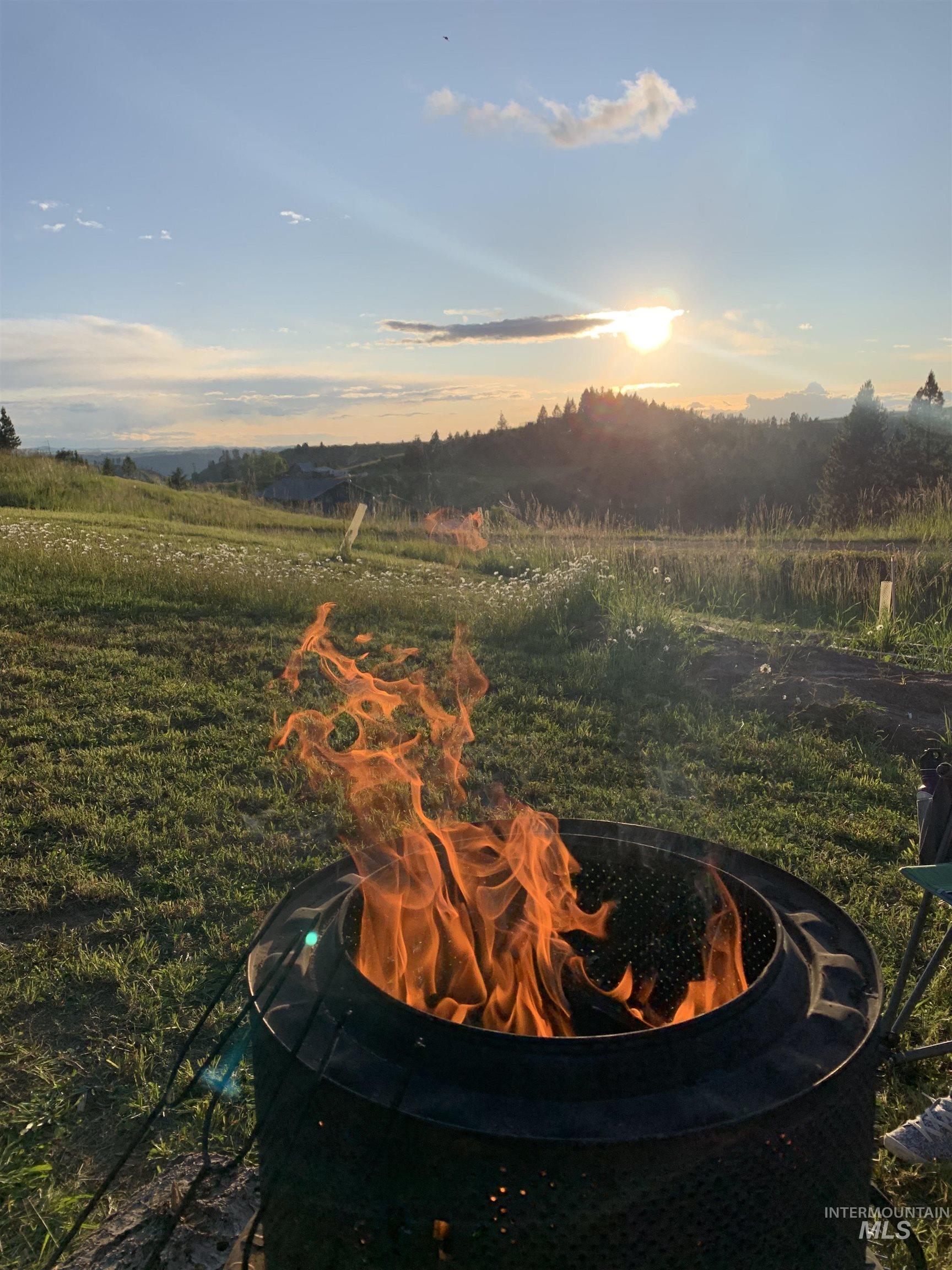 Yard at dusk with an outdoor fire pit