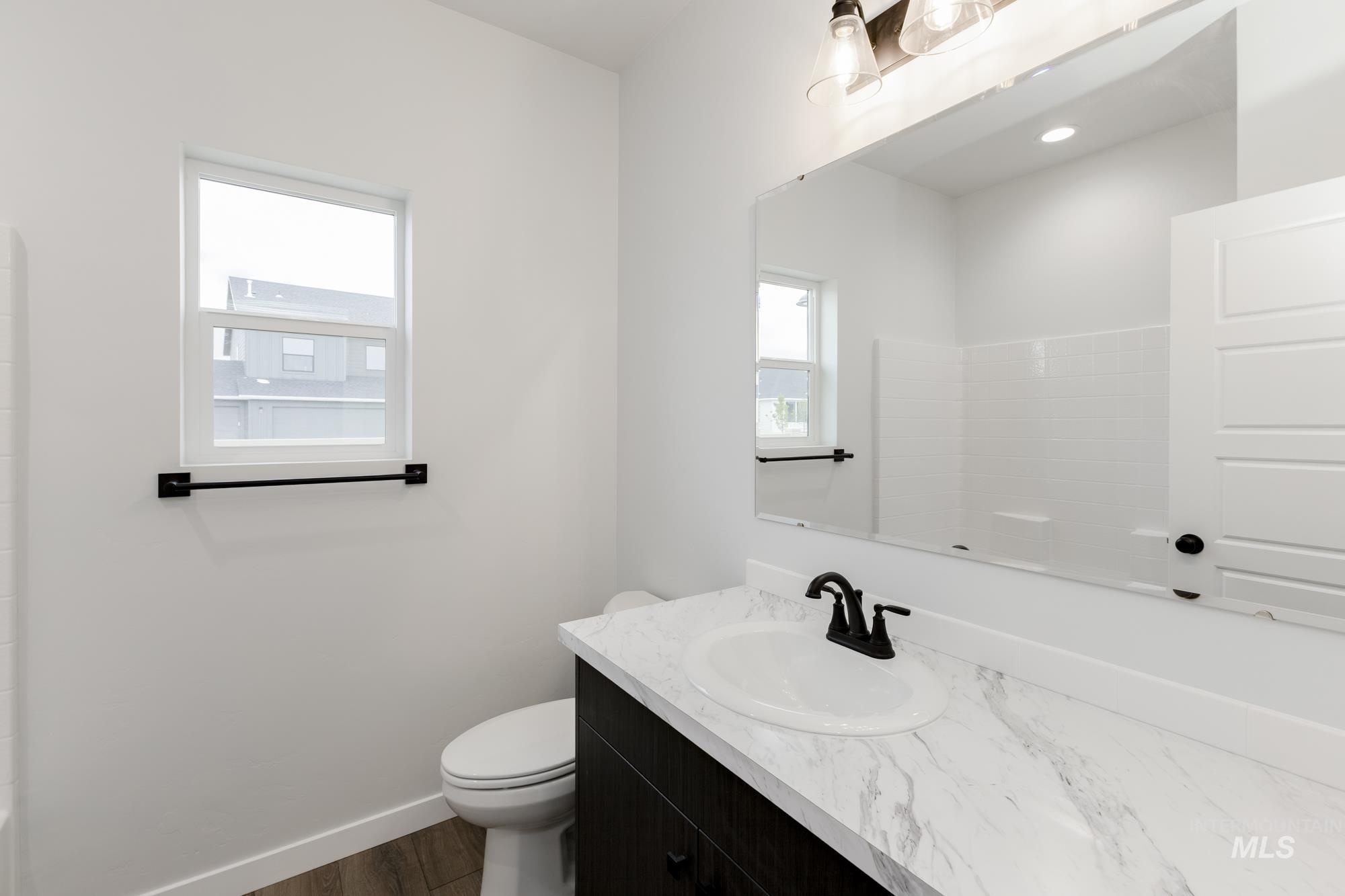 Bathroom featuring vanity and wood finished floors