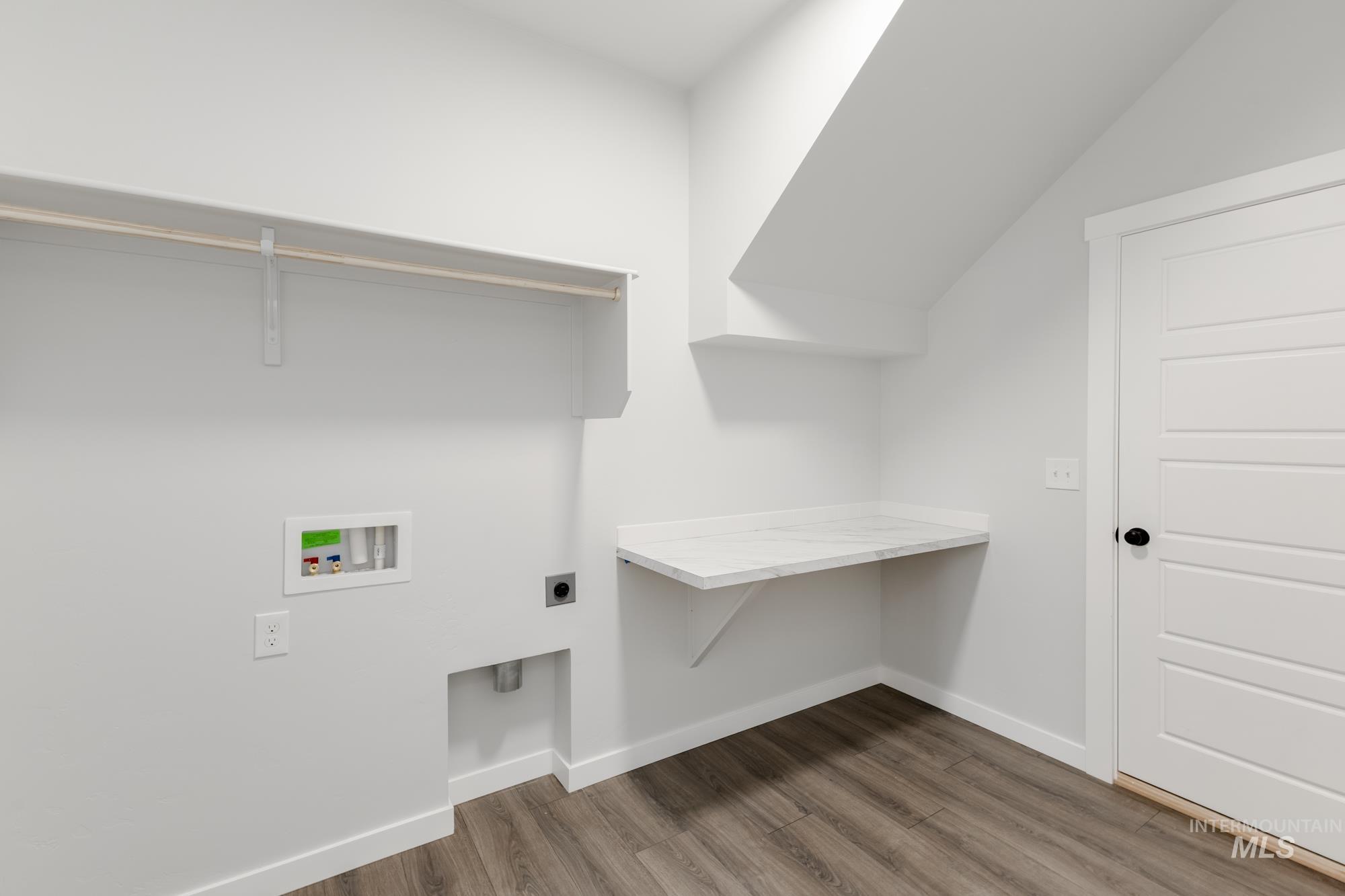 Laundry room featuring electric dryer hookup, washer hookup, and dark wood finished floors