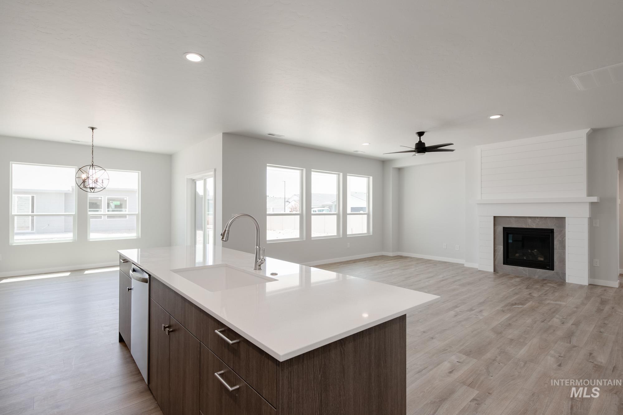 Kitchen with dishwashing machine, a ceiling fan, healthy amount of natural light, light countertops, and recessed lighting