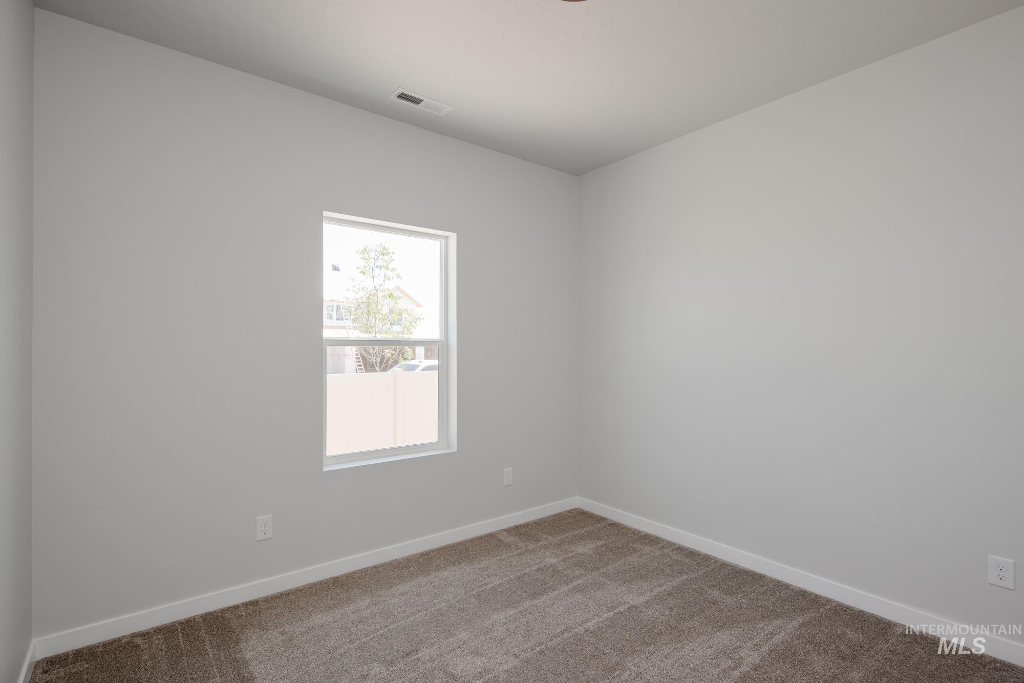 Empty room with baseboards and carpet floors