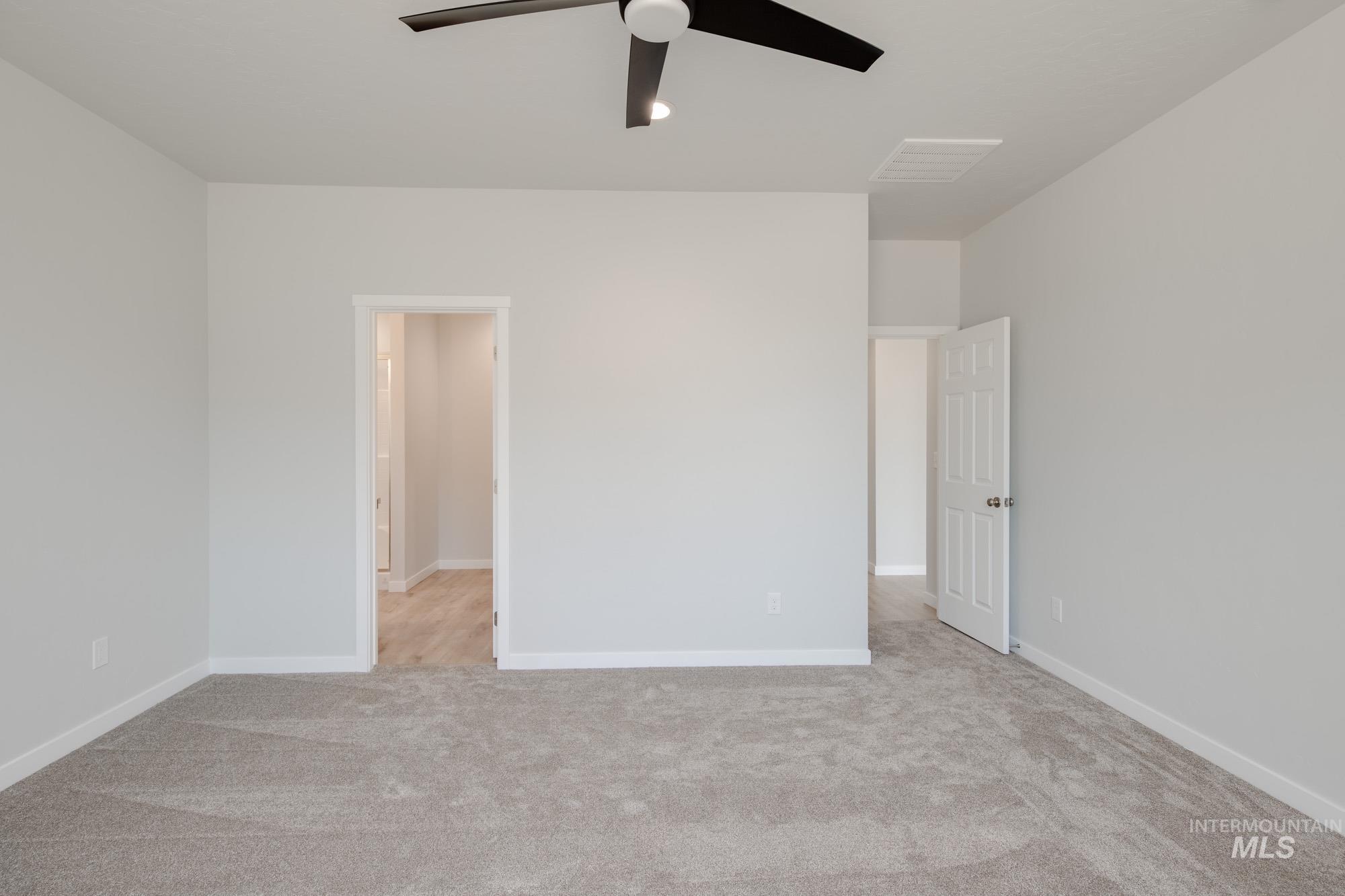 Unfurnished bedroom featuring carpet floors and ceiling fan
