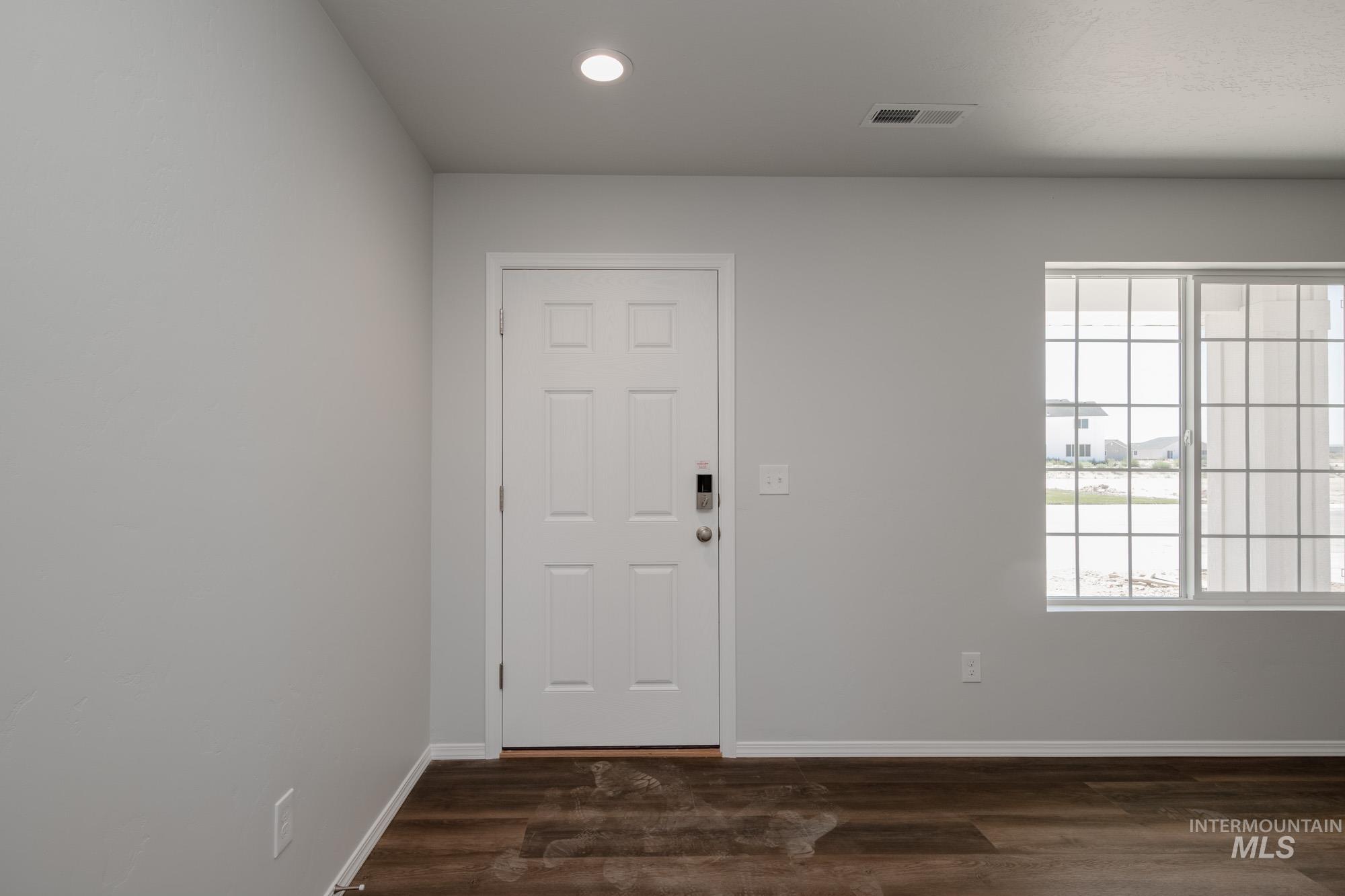 Entrance foyer featuring recessed lighting and dark wood finished floors