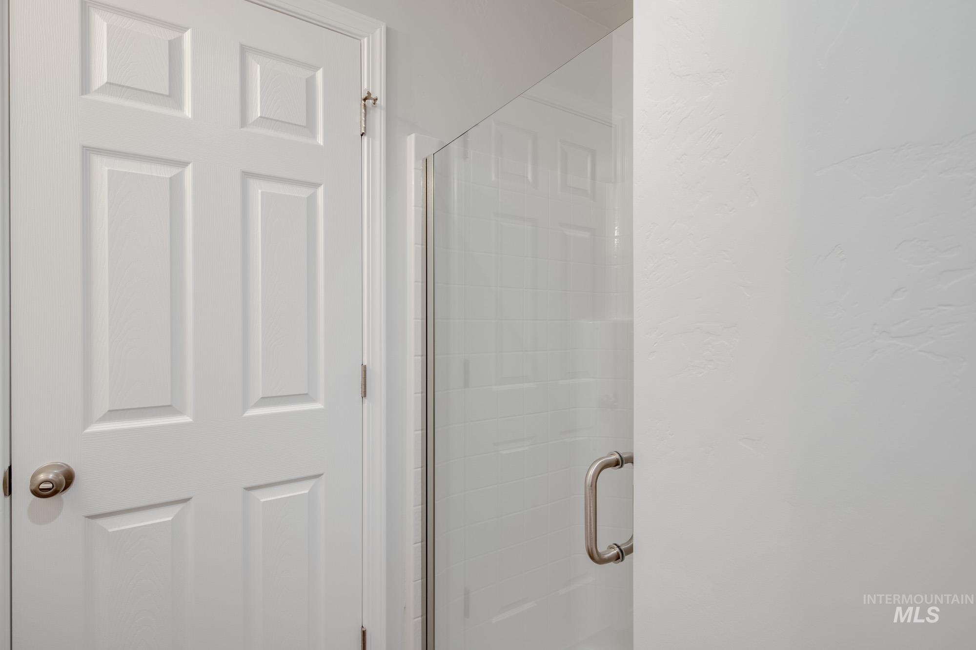 Full bathroom with a shower stall