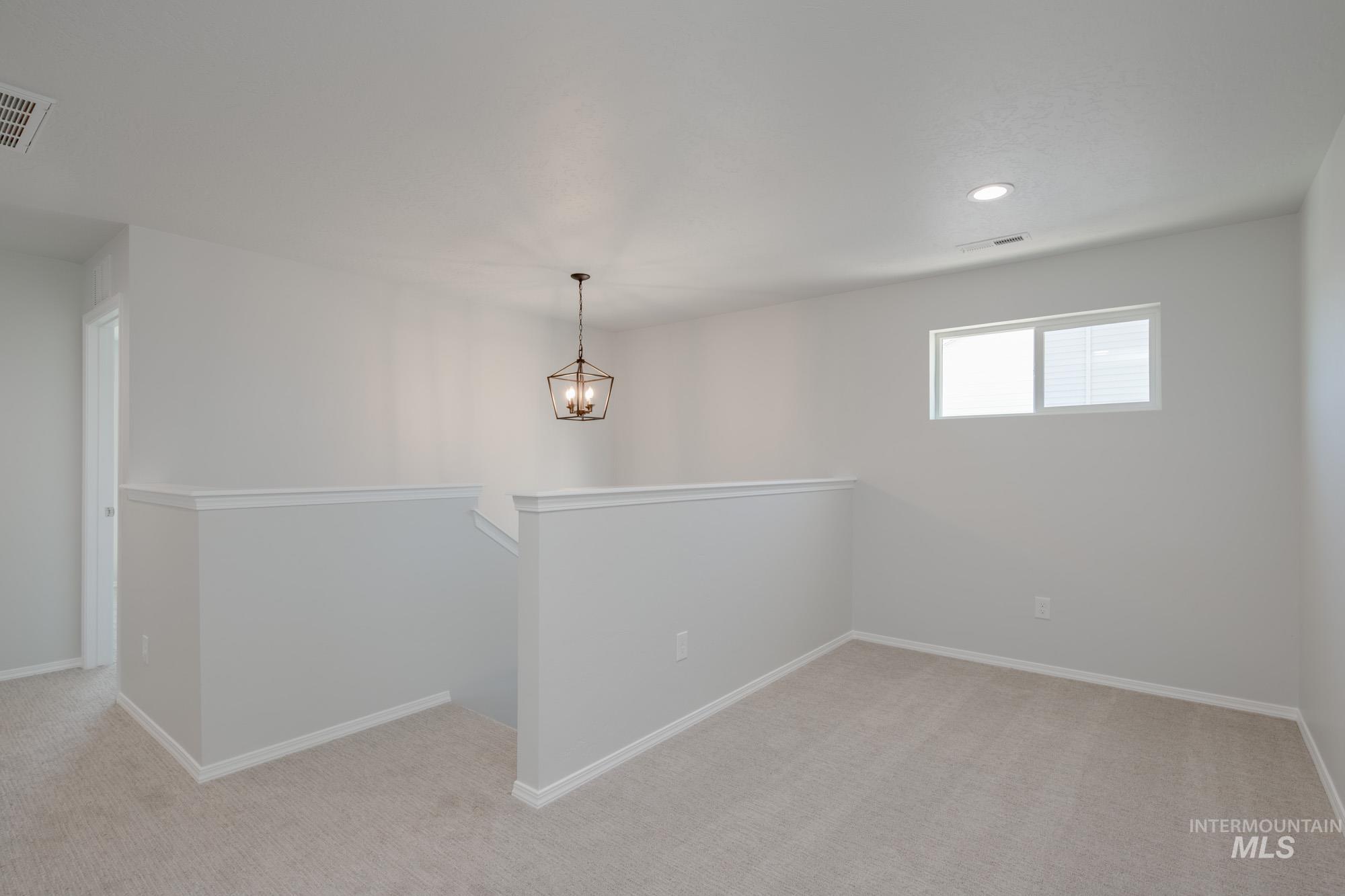 Spare room featuring light carpet and recessed lighting