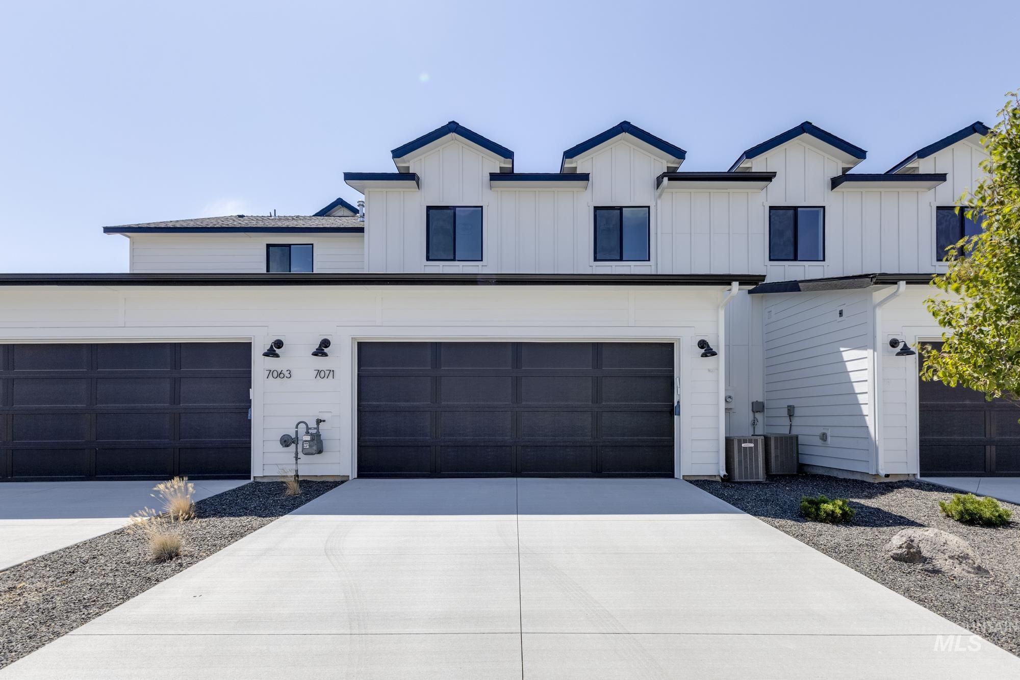 Modern farmhouse with driveway and board and batten siding