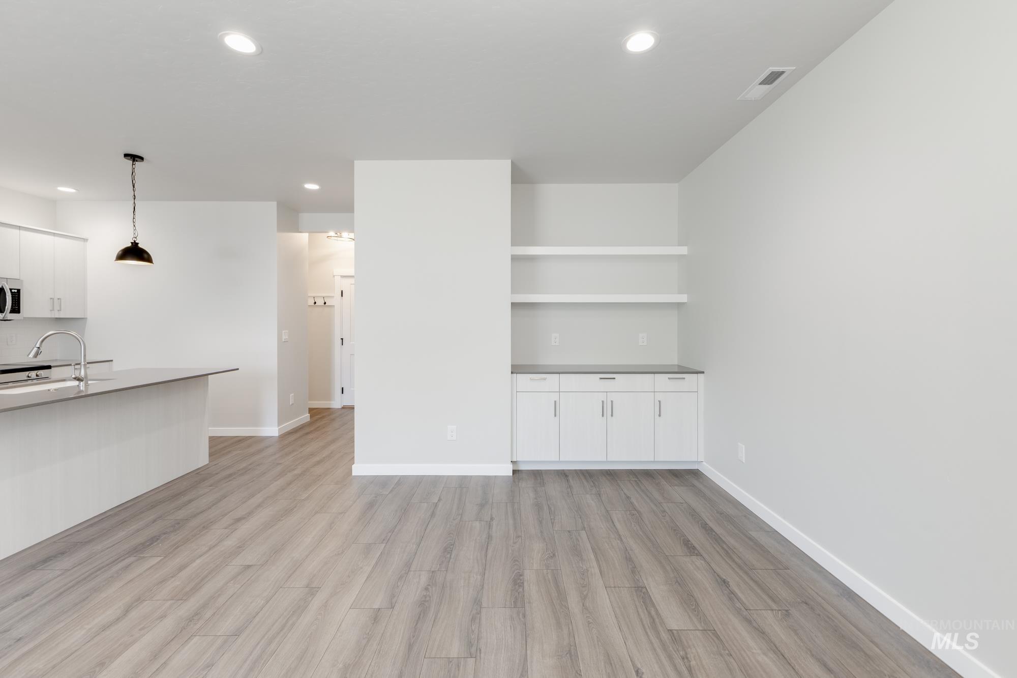 Unfurnished living room with light wood finished floors and recessed lighting