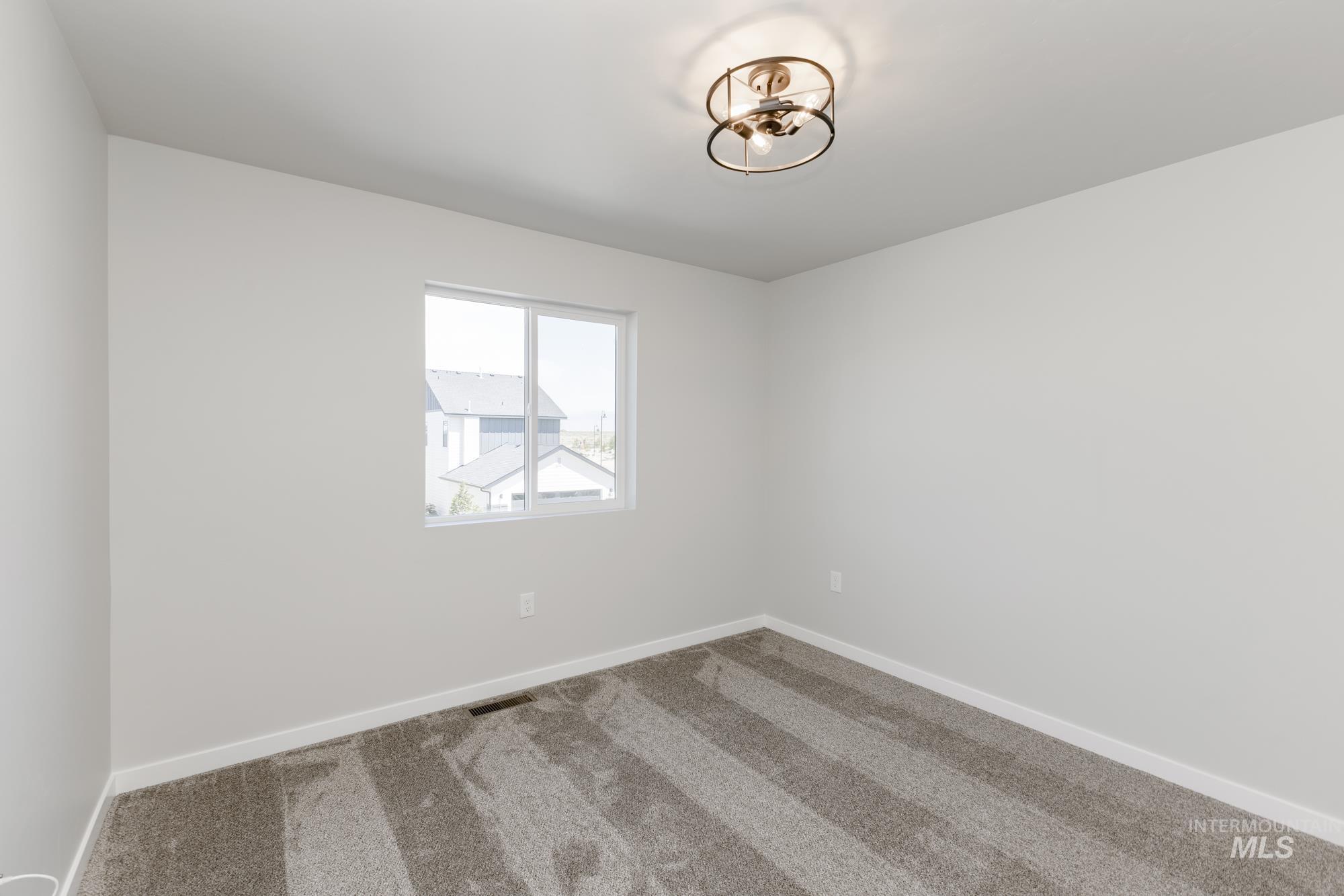 Empty room with carpet flooring and baseboards