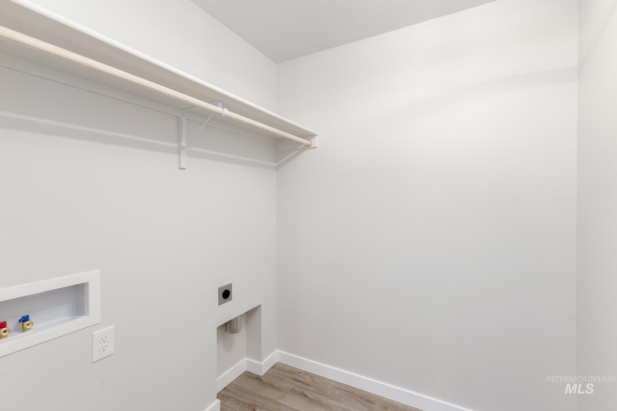 Laundry room featuring washer hookup, hookup for an electric dryer, and light wood-style flooring