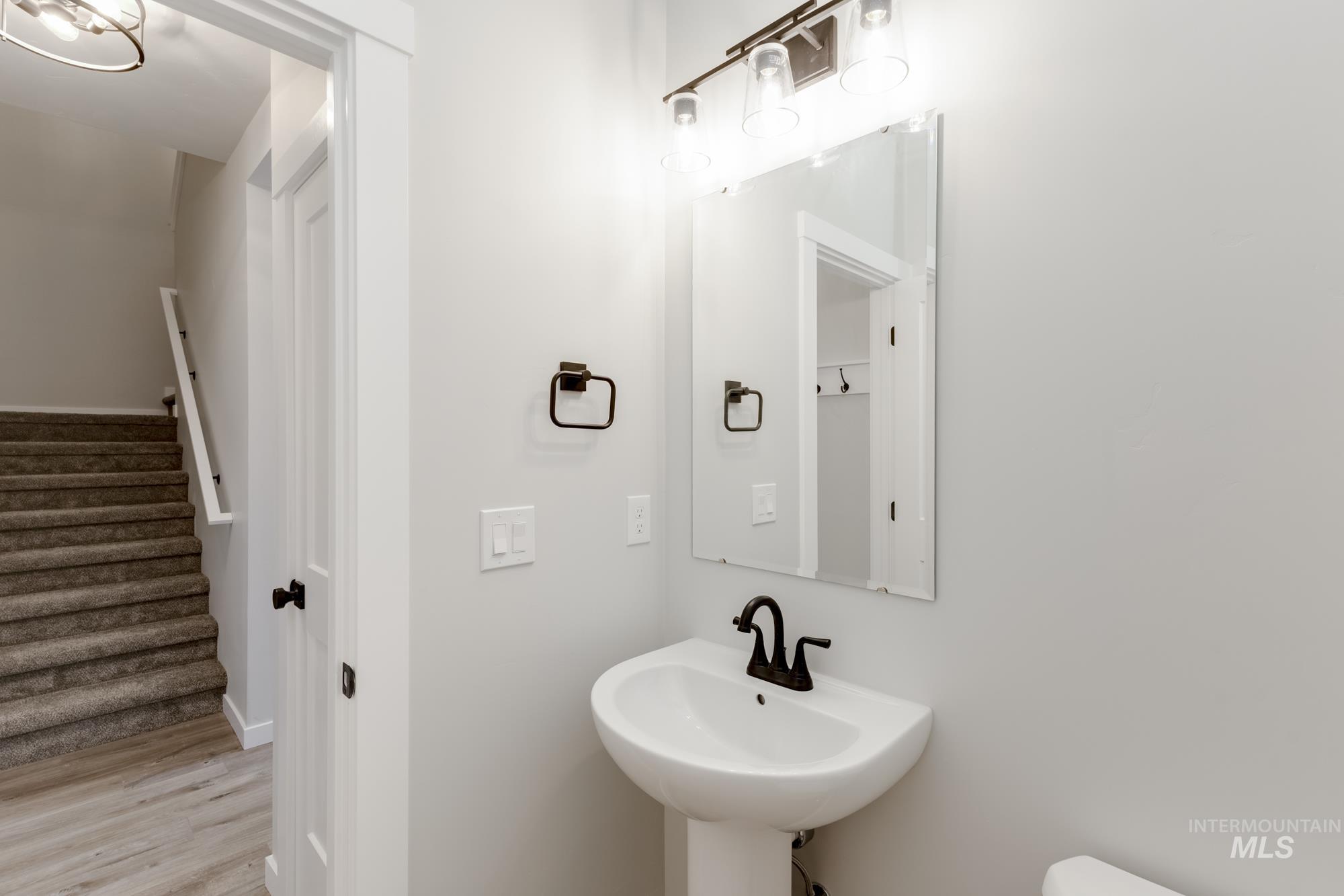 Bathroom with wood finished floors and toilet