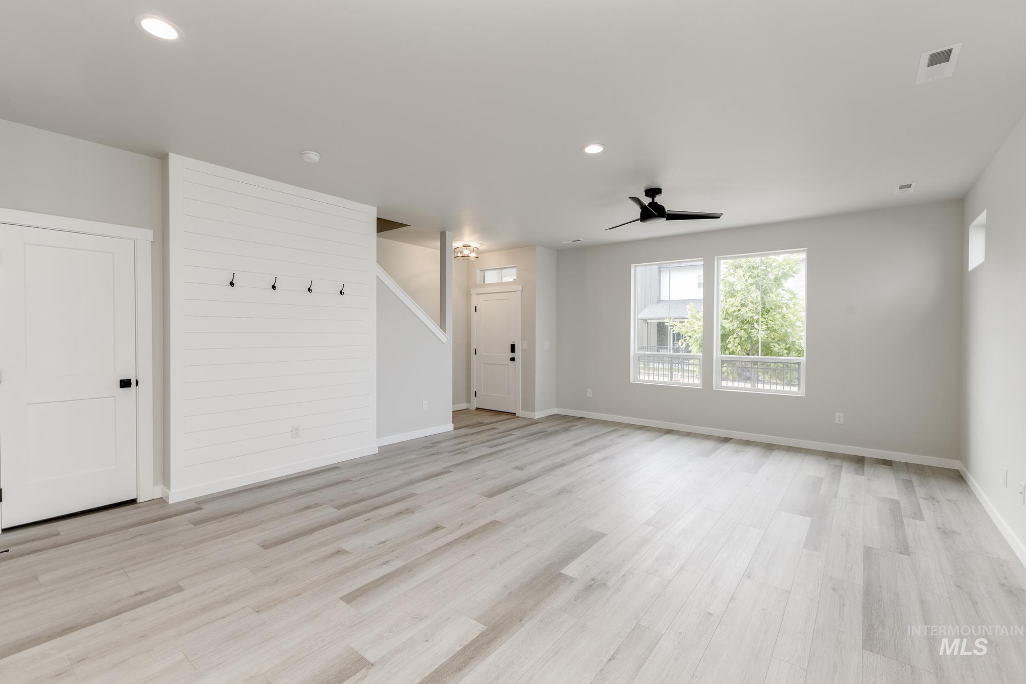 Unfurnished living room featuring recessed lighting, light wood-type flooring, and a ceiling fan