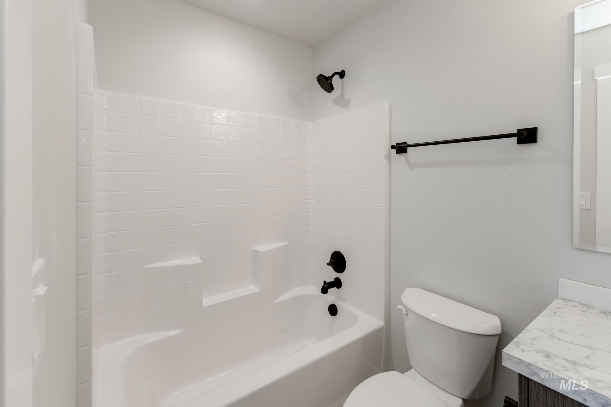 Bathroom featuring vanity and tub / shower combination