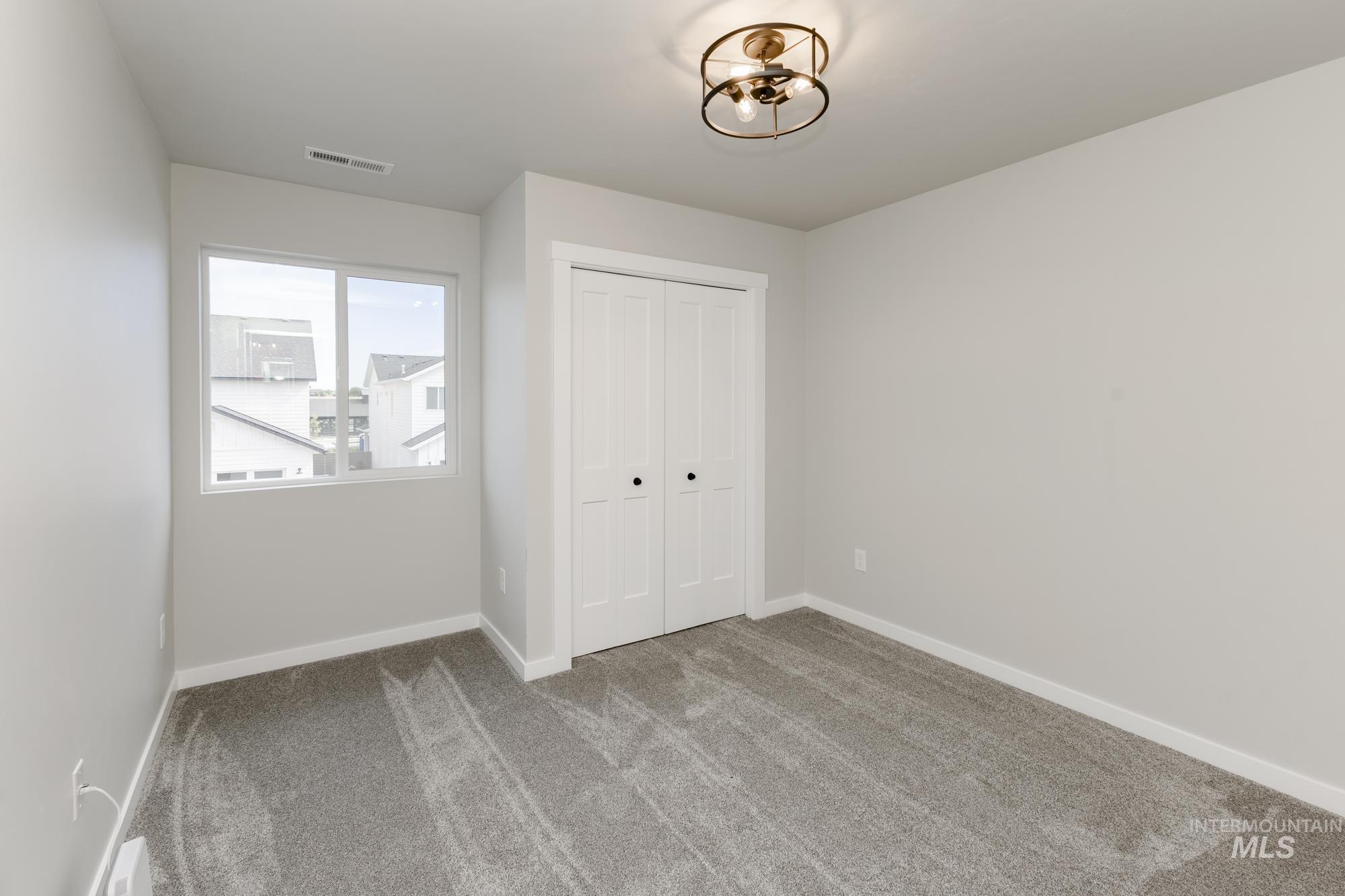 Unfurnished bedroom featuring carpet and a closet