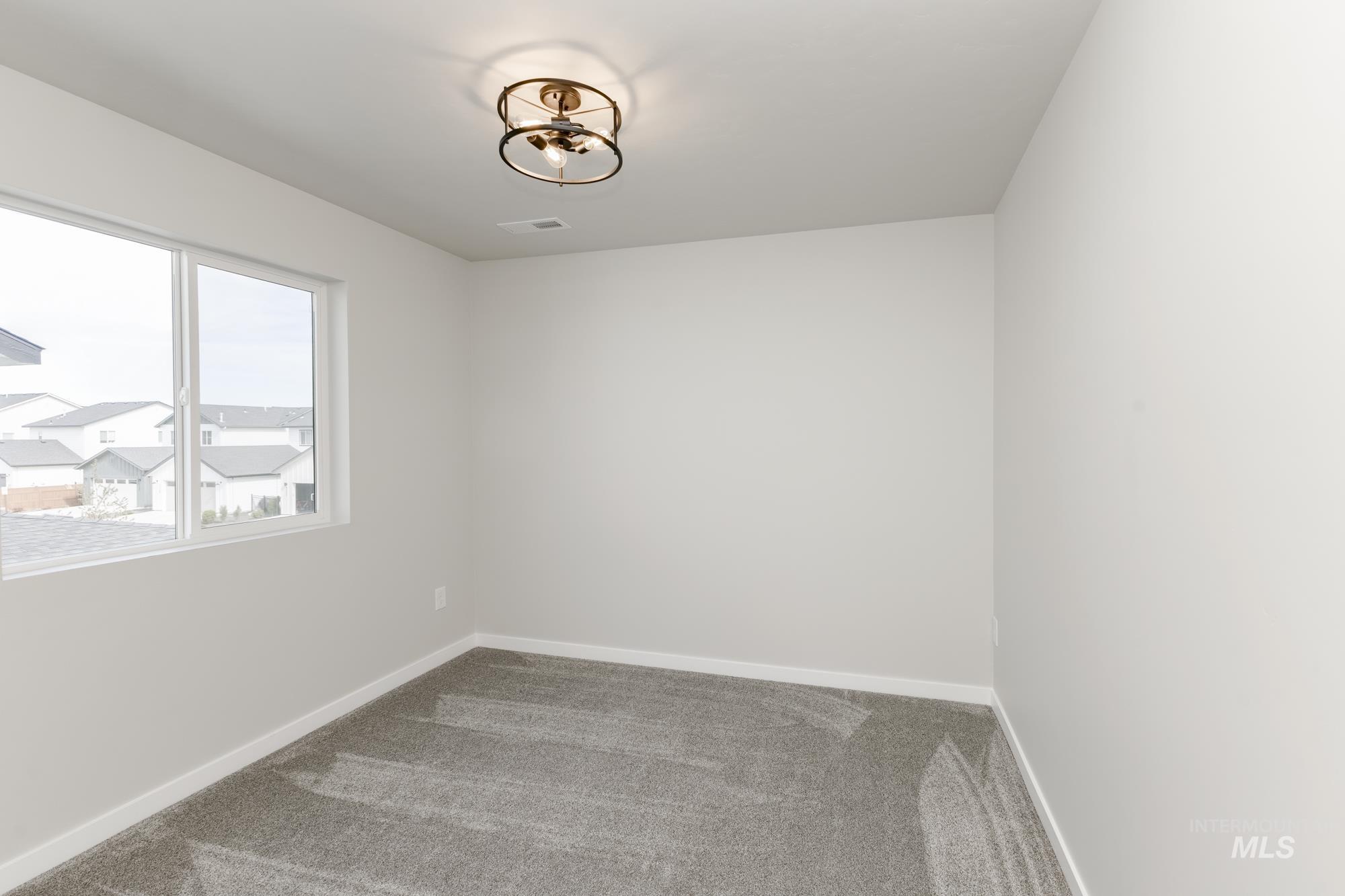 Carpeted empty room with baseboards