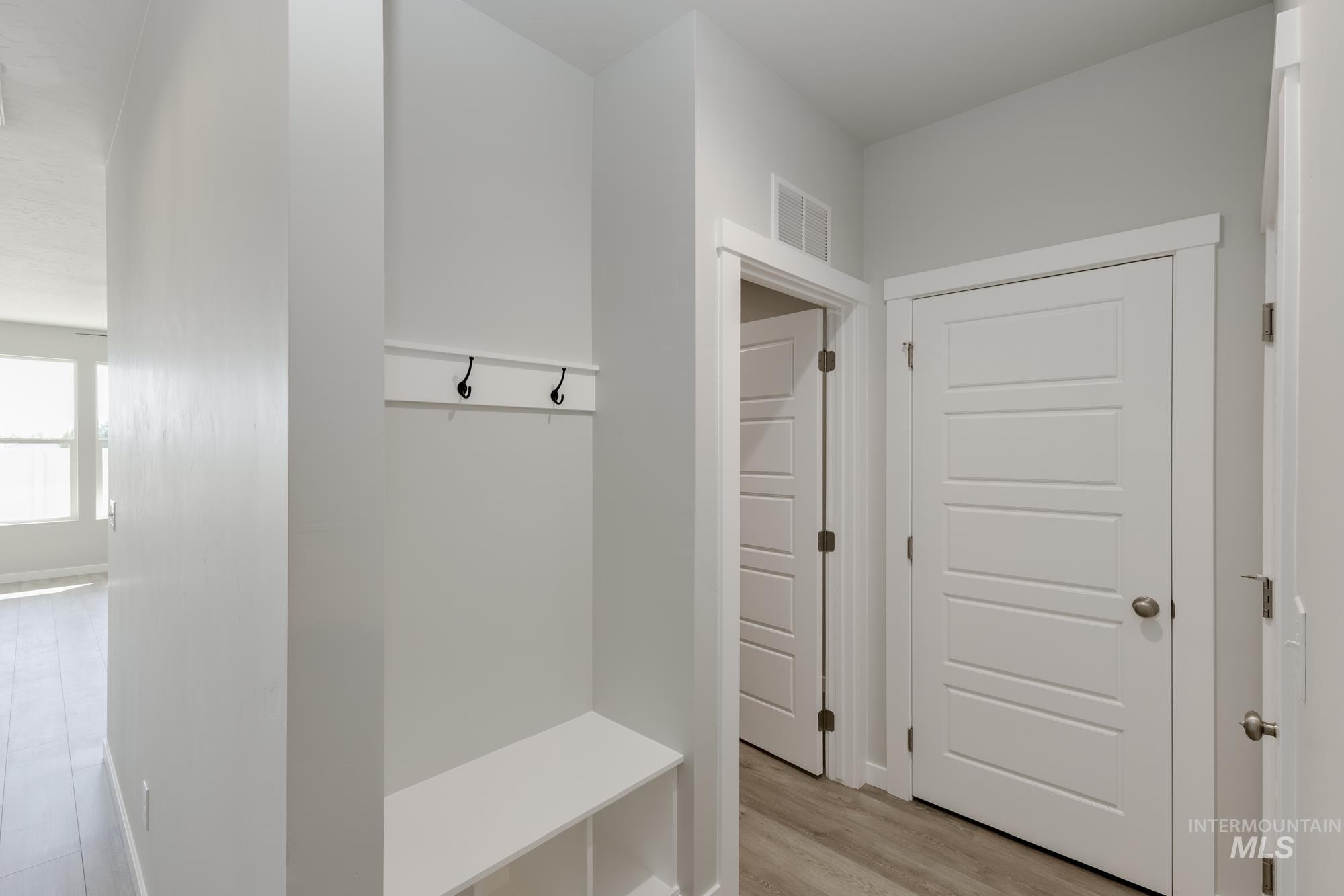 Mudroom with light wood-style flooring