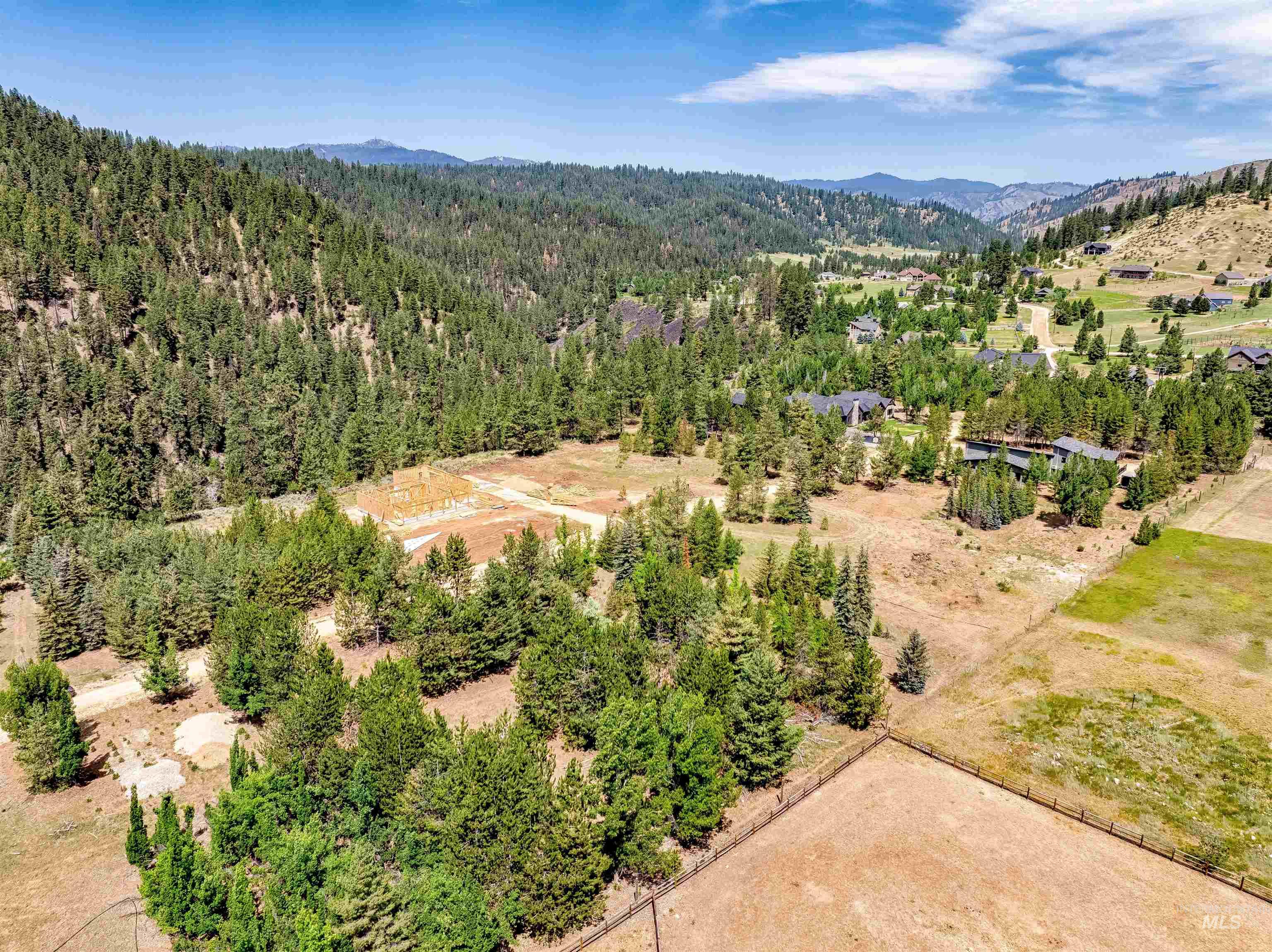 Aerial view of a mountain backdrop and a heavily wooded area