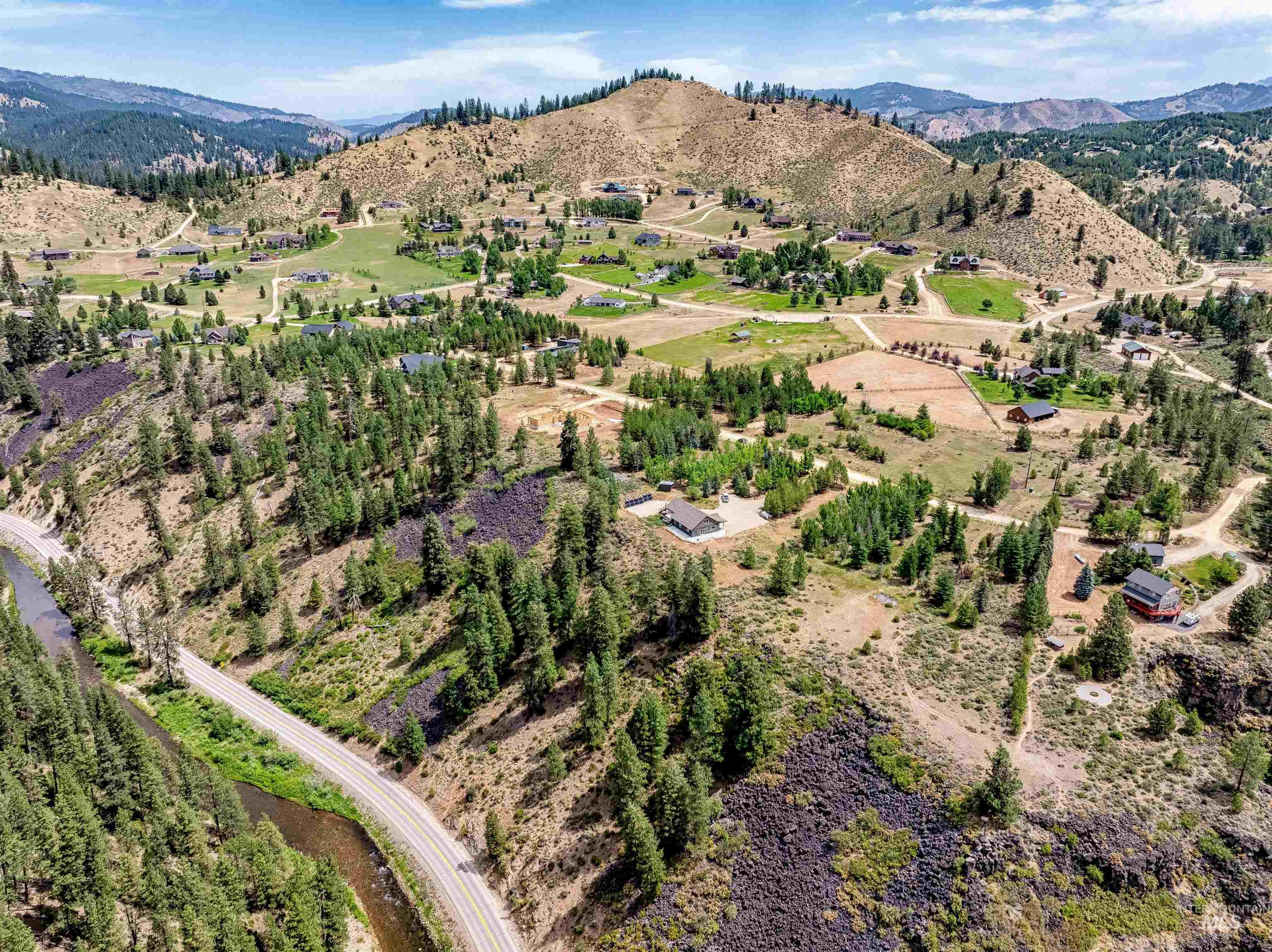 Aerial overview of property's location featuring a mountainous background