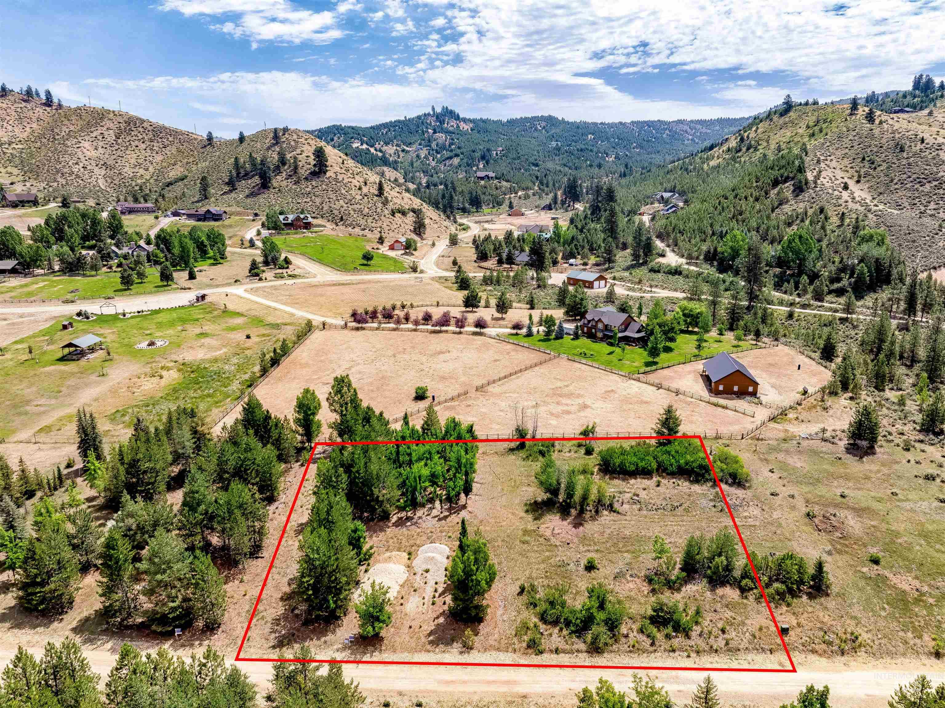 Overview of rural landscape featuring property boundaries highlighted and a mountainous background