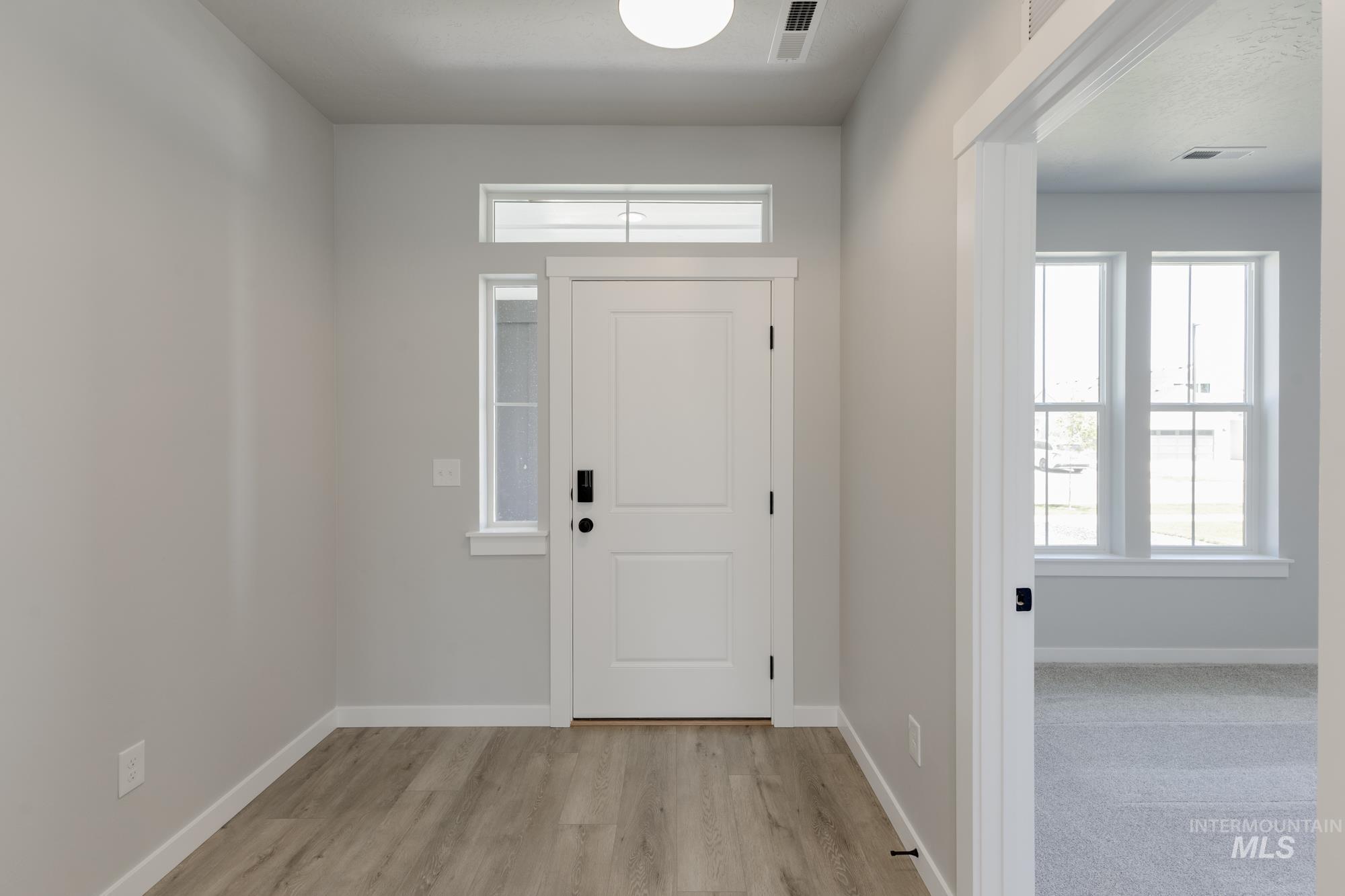 Entrance foyer featuring light wood-type flooring and baseboards