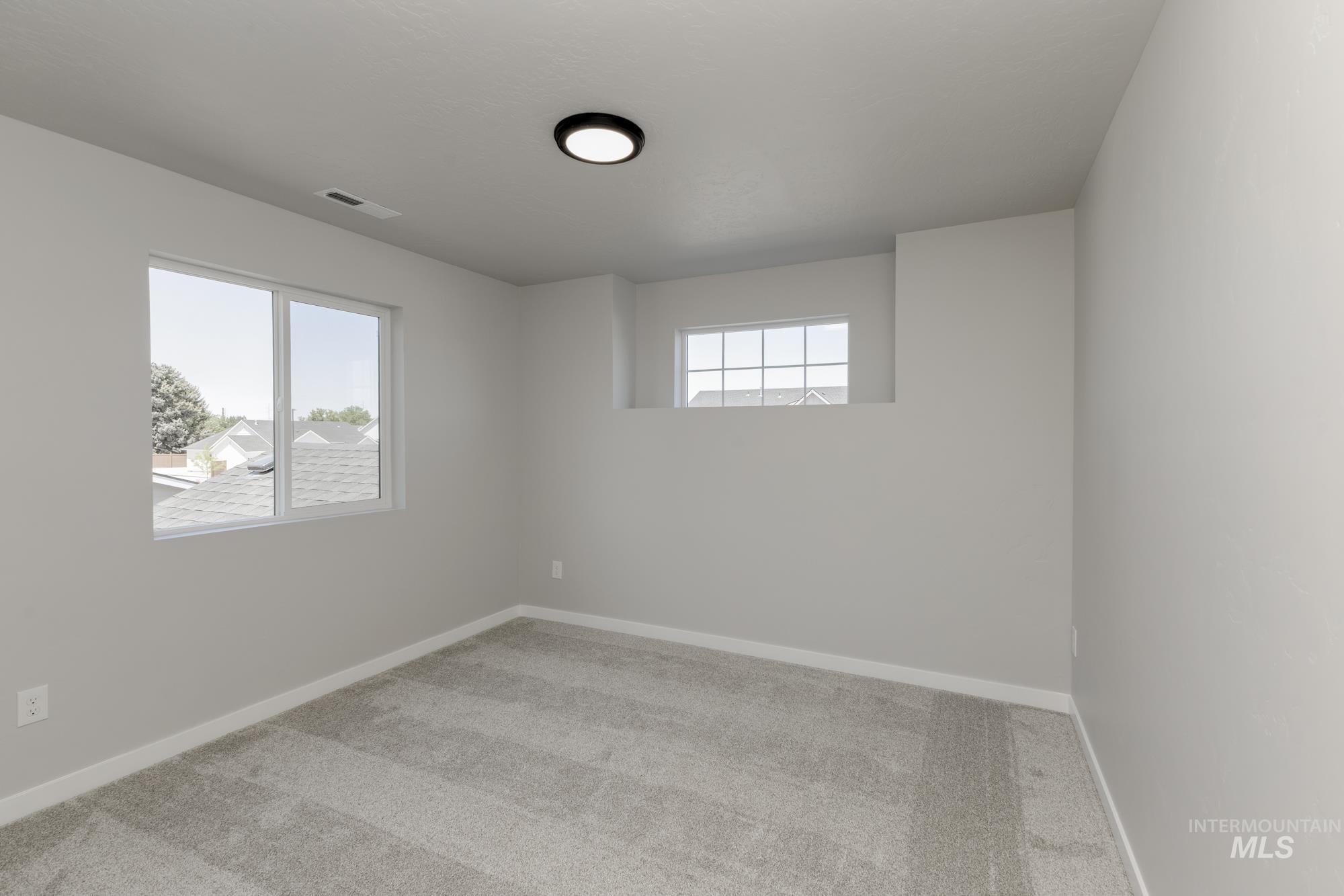 Unfurnished room featuring carpet floors and baseboards