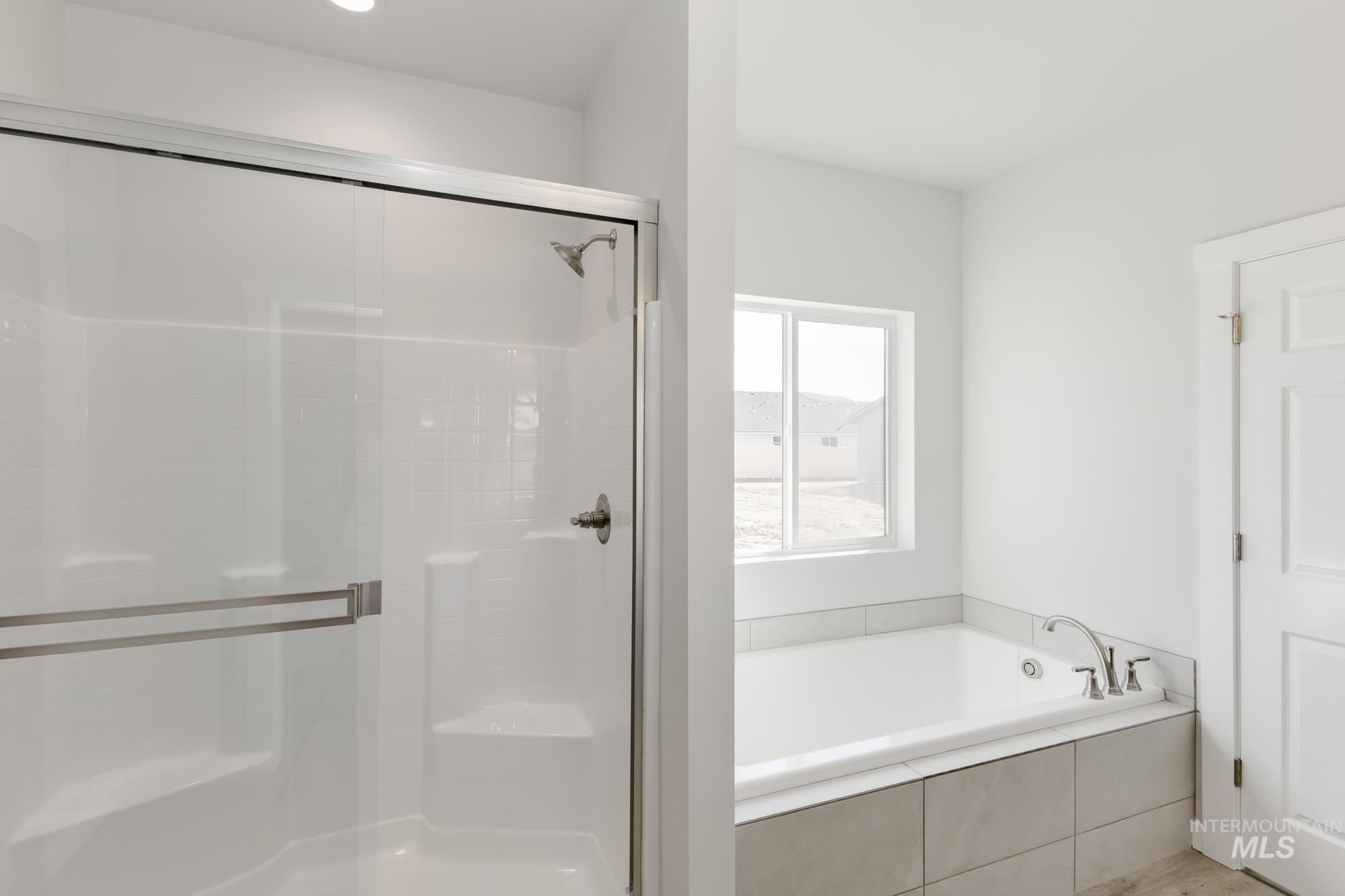 Full bathroom with a shower stall and a garden tub