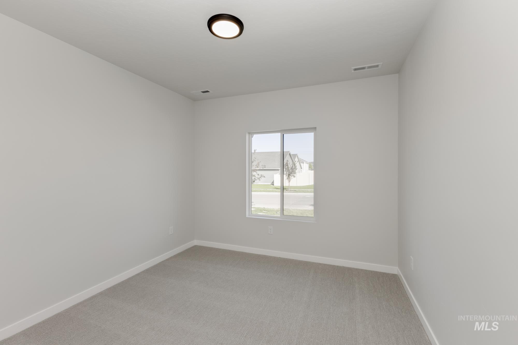 Unfurnished room featuring light carpet