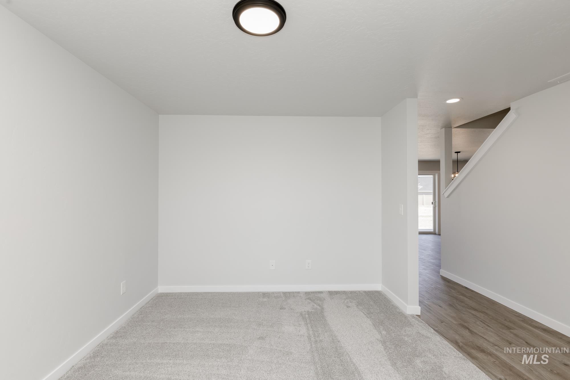 Spare room featuring baseboards and recessed lighting