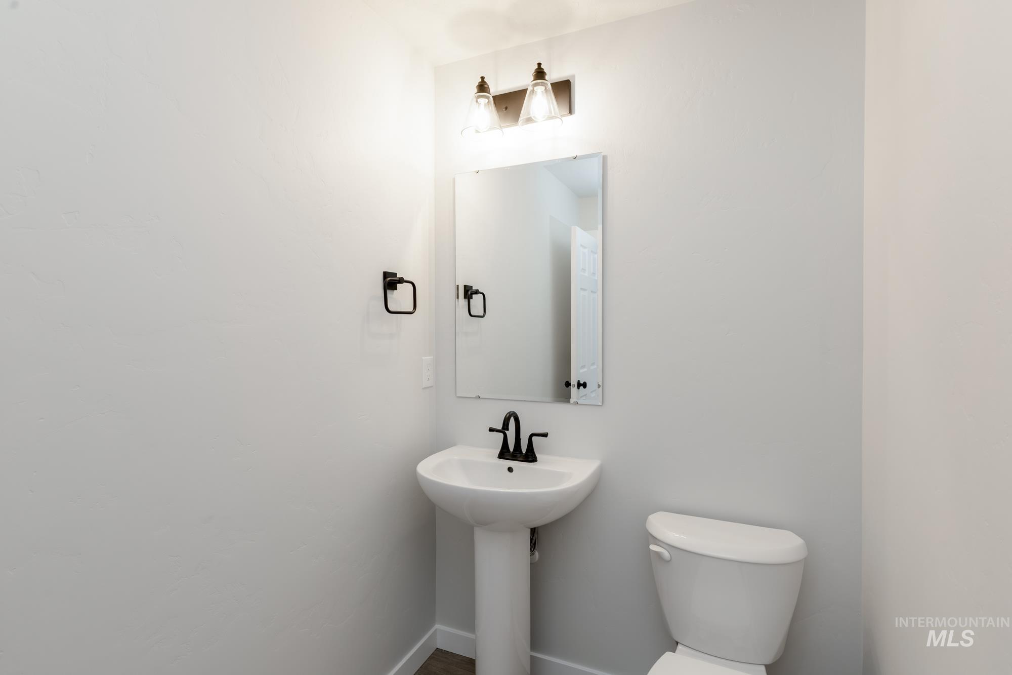 Bathroom with toilet and baseboards
