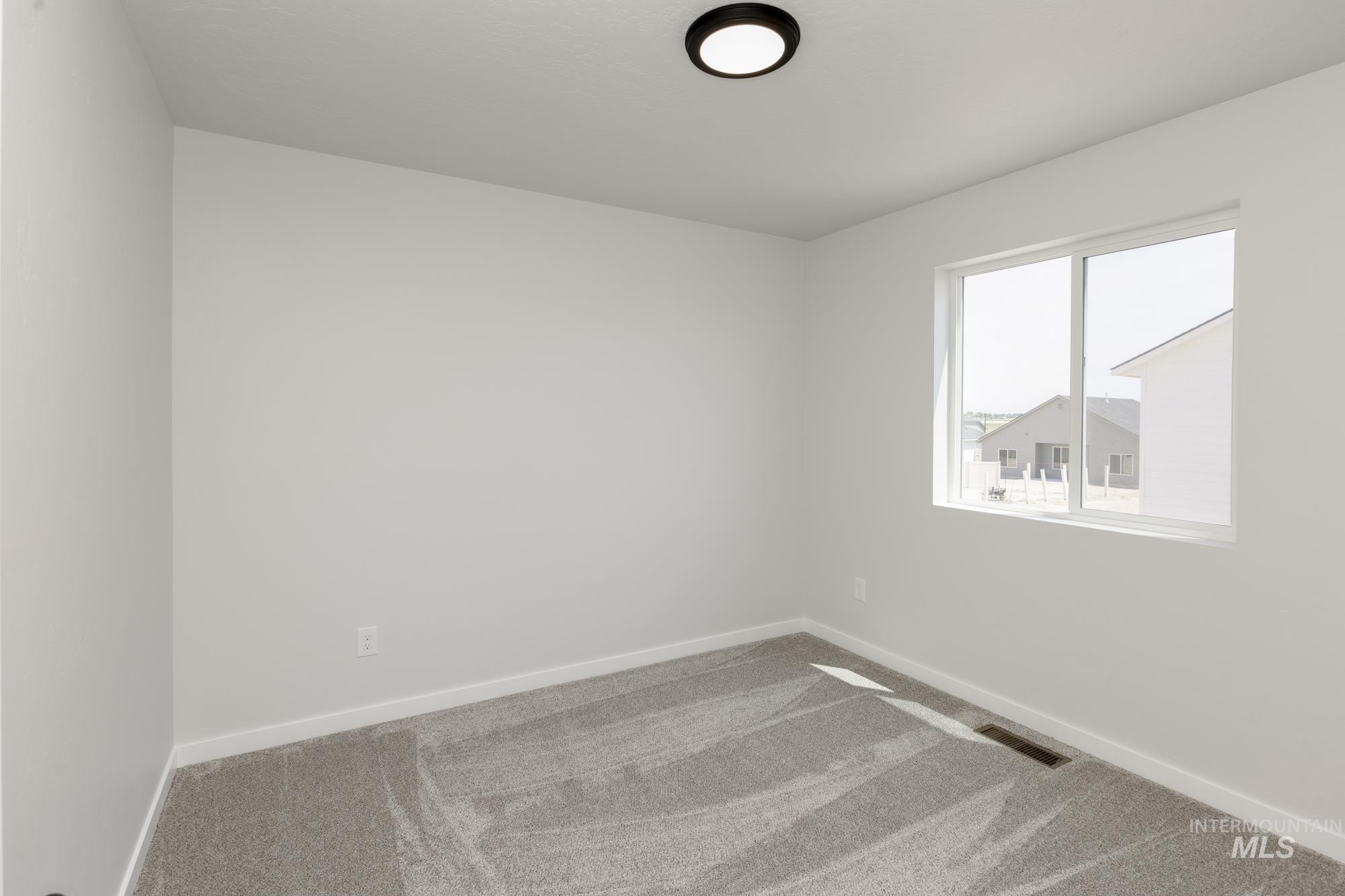 Unfurnished room featuring carpet and baseboards