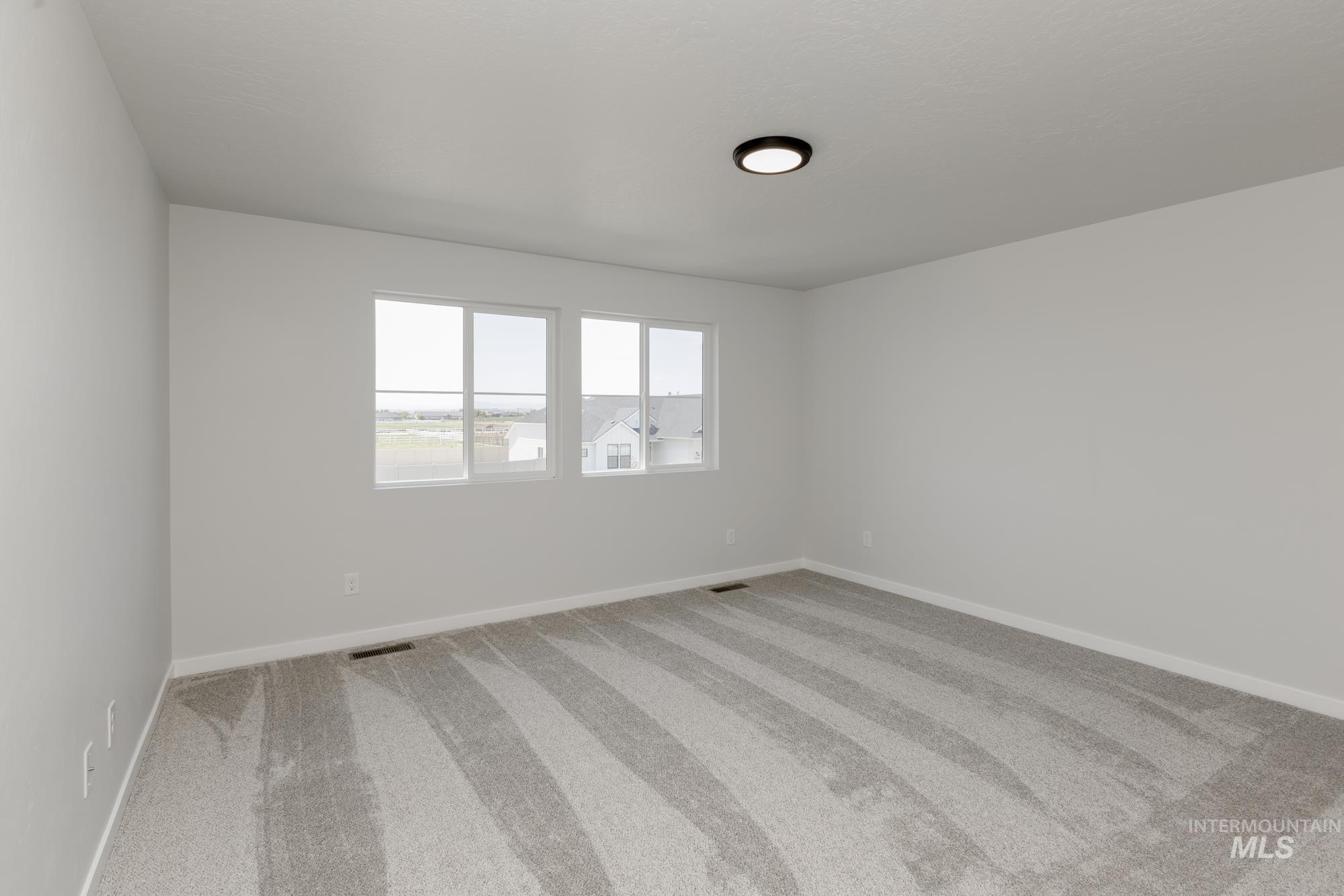 Spare room with carpet flooring and baseboards