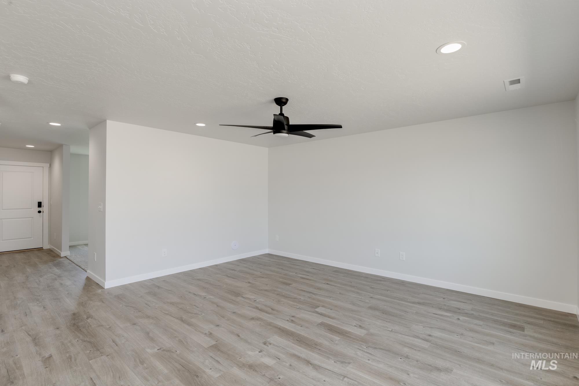 Unfurnished room with ceiling fan, light wood finished floors, and recessed lighting