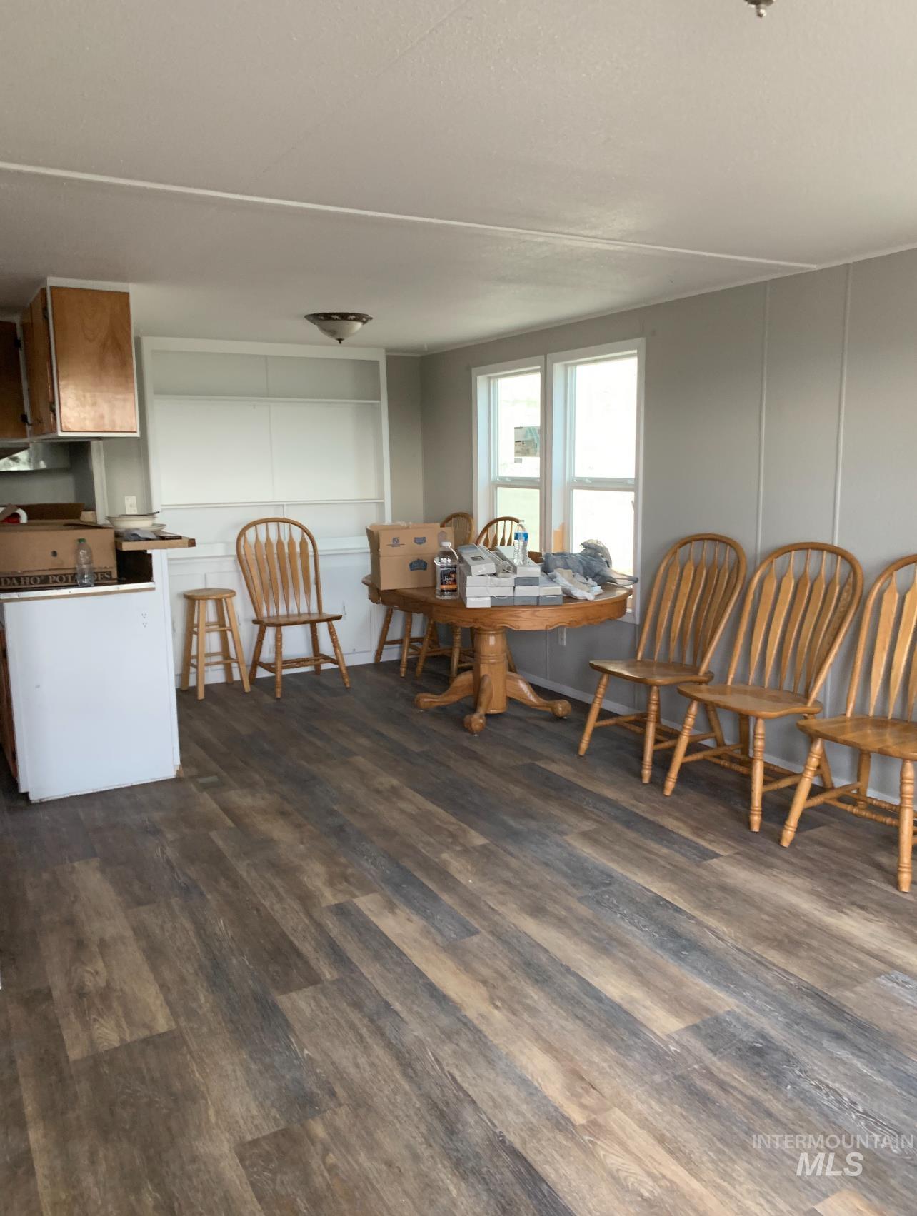 Dining space with dark wood-type flooring