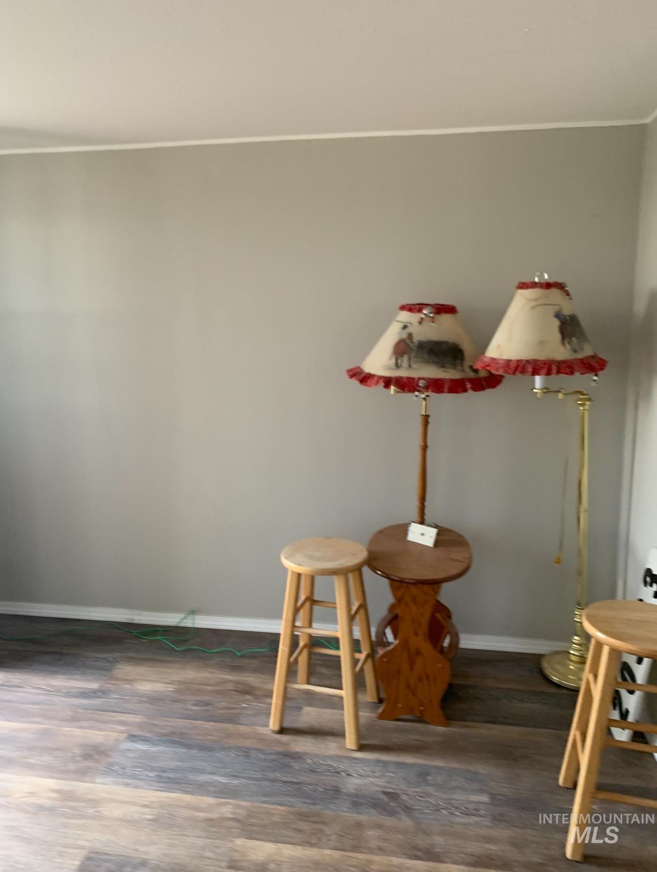 Dining area with wood finished floors and crown molding