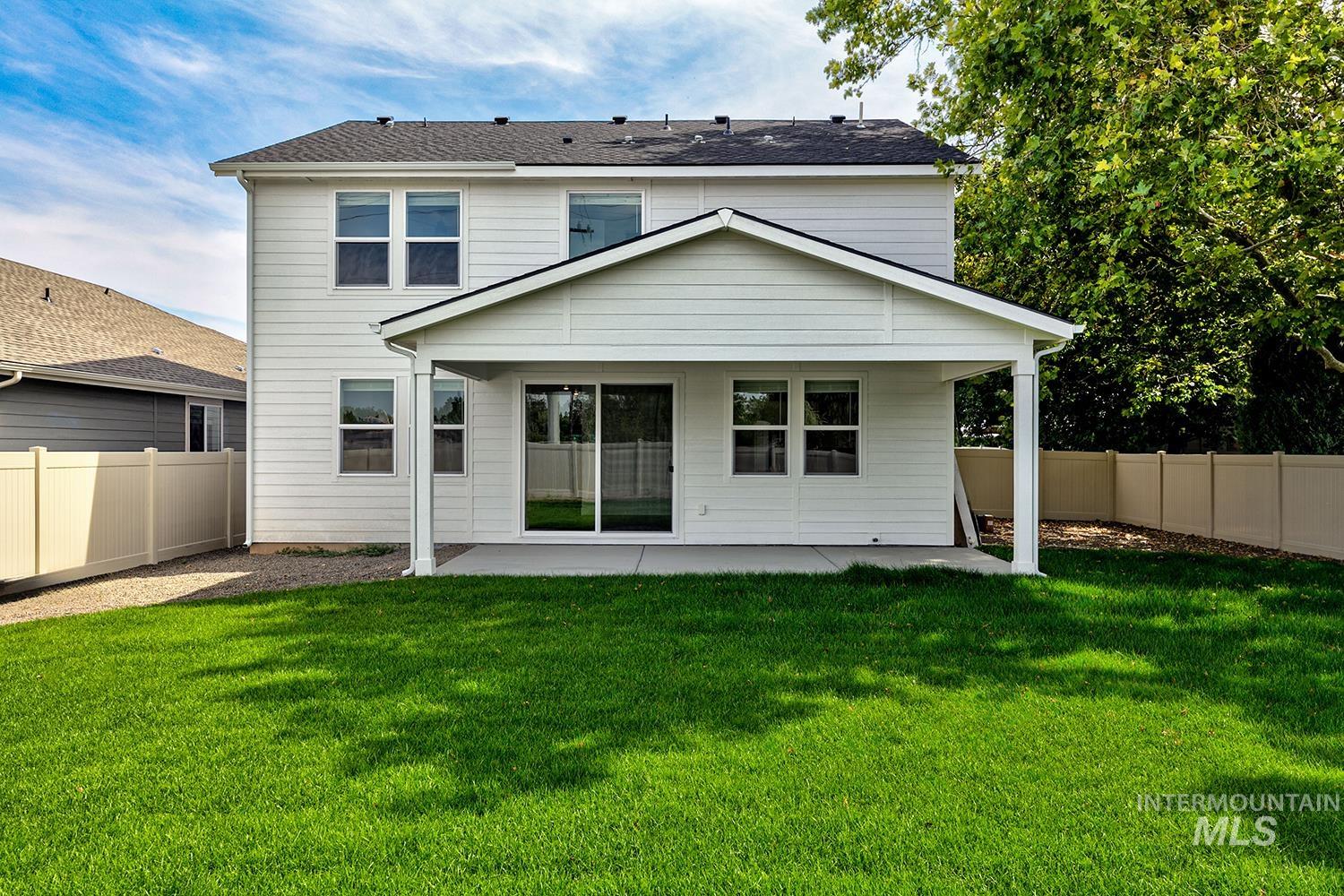 Back of property featuring a patio and a fenced backyard