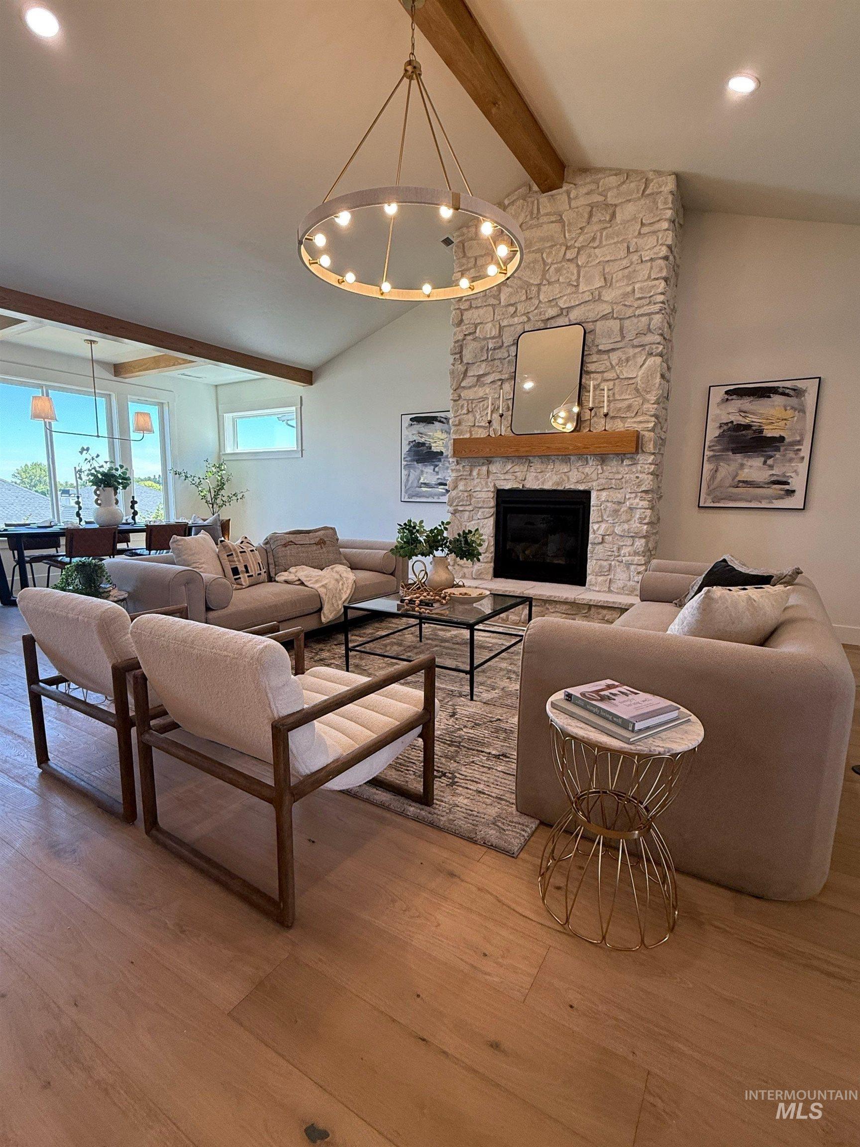 Living area with a chandelier, light wood-style flooring, a fireplace, and recessed lighting