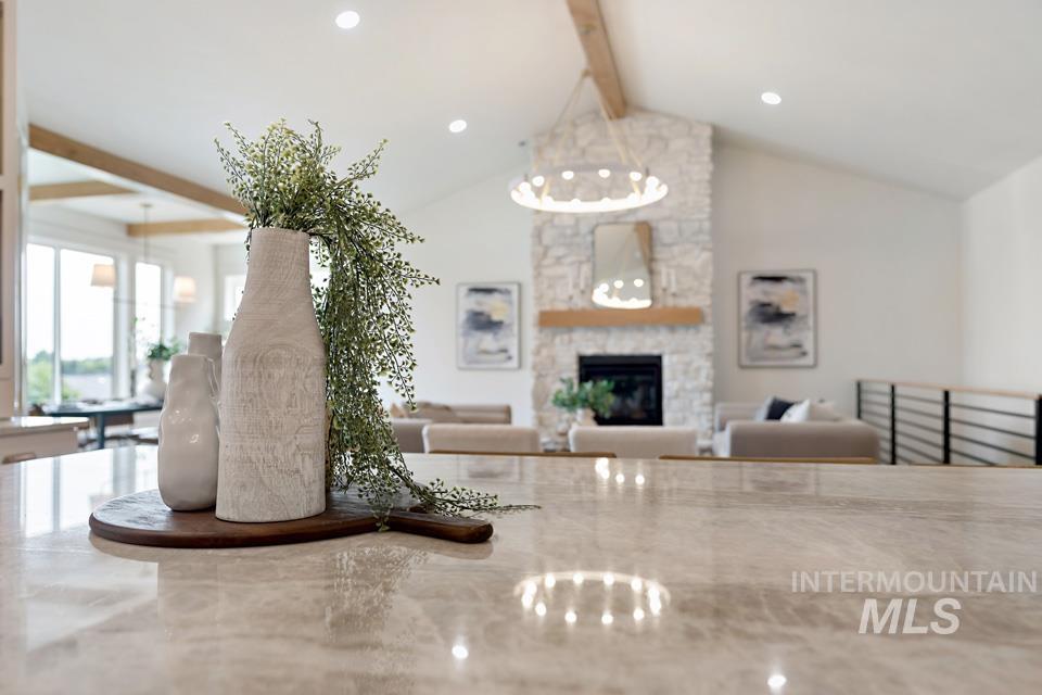 Living area with beam ceiling, a chandelier, a fireplace, recessed lighting, and high vaulted ceiling
