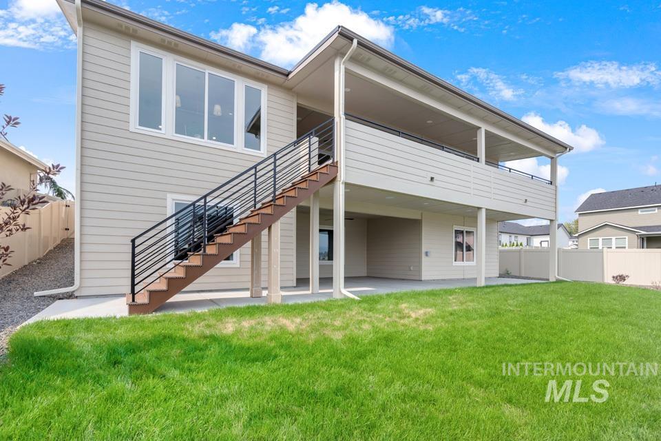 Rear view of property featuring a patio area, stairway, and a deck