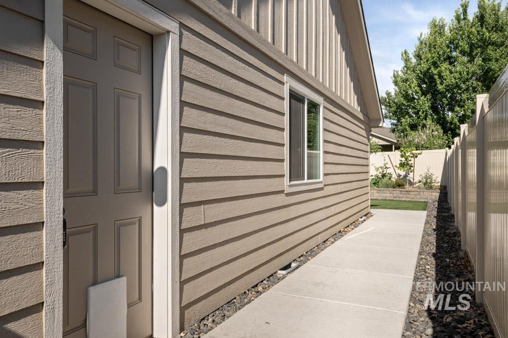 View of side of home with a fenced backyard