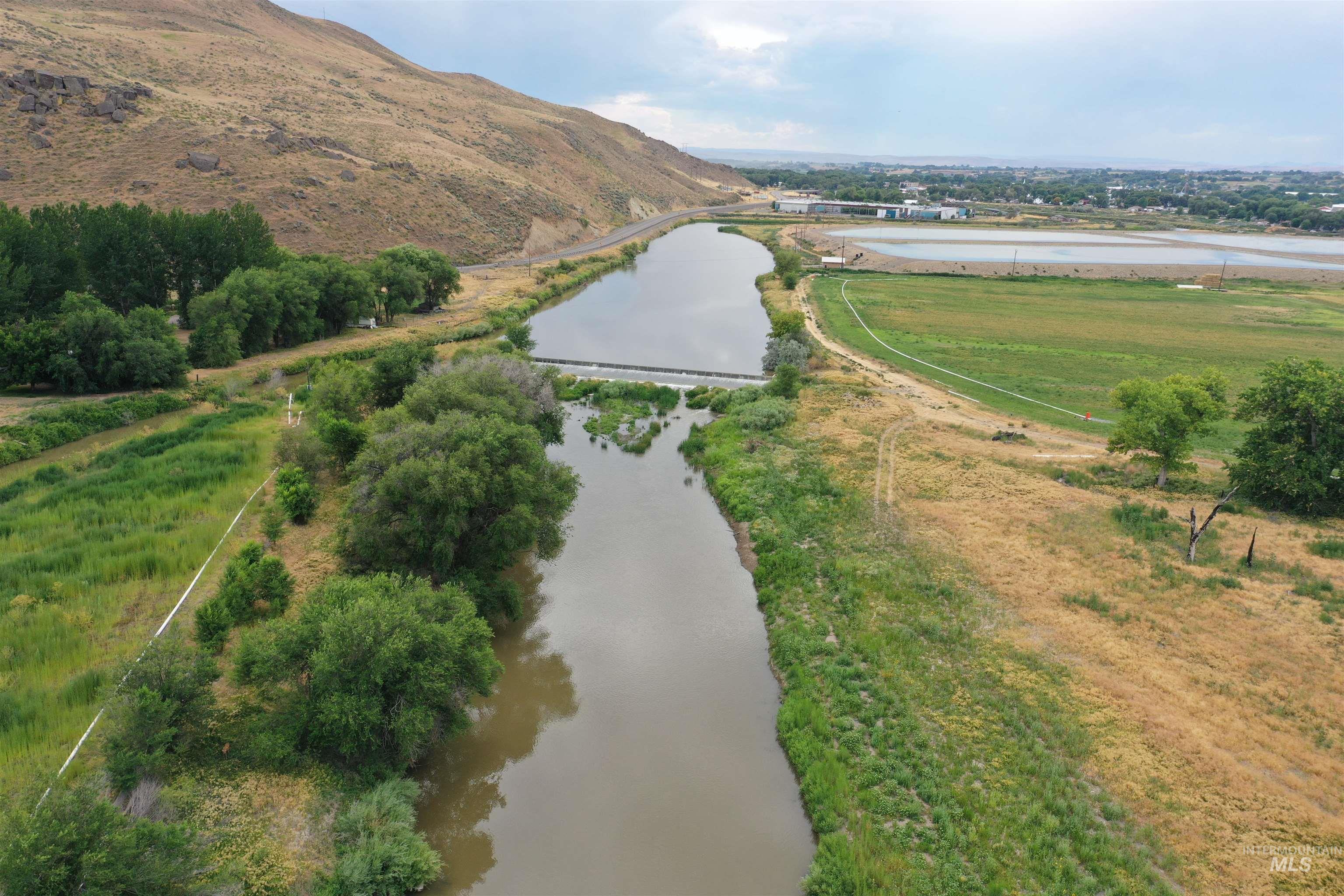 Aerial view of property and surrounding area featuring a nearby body of water