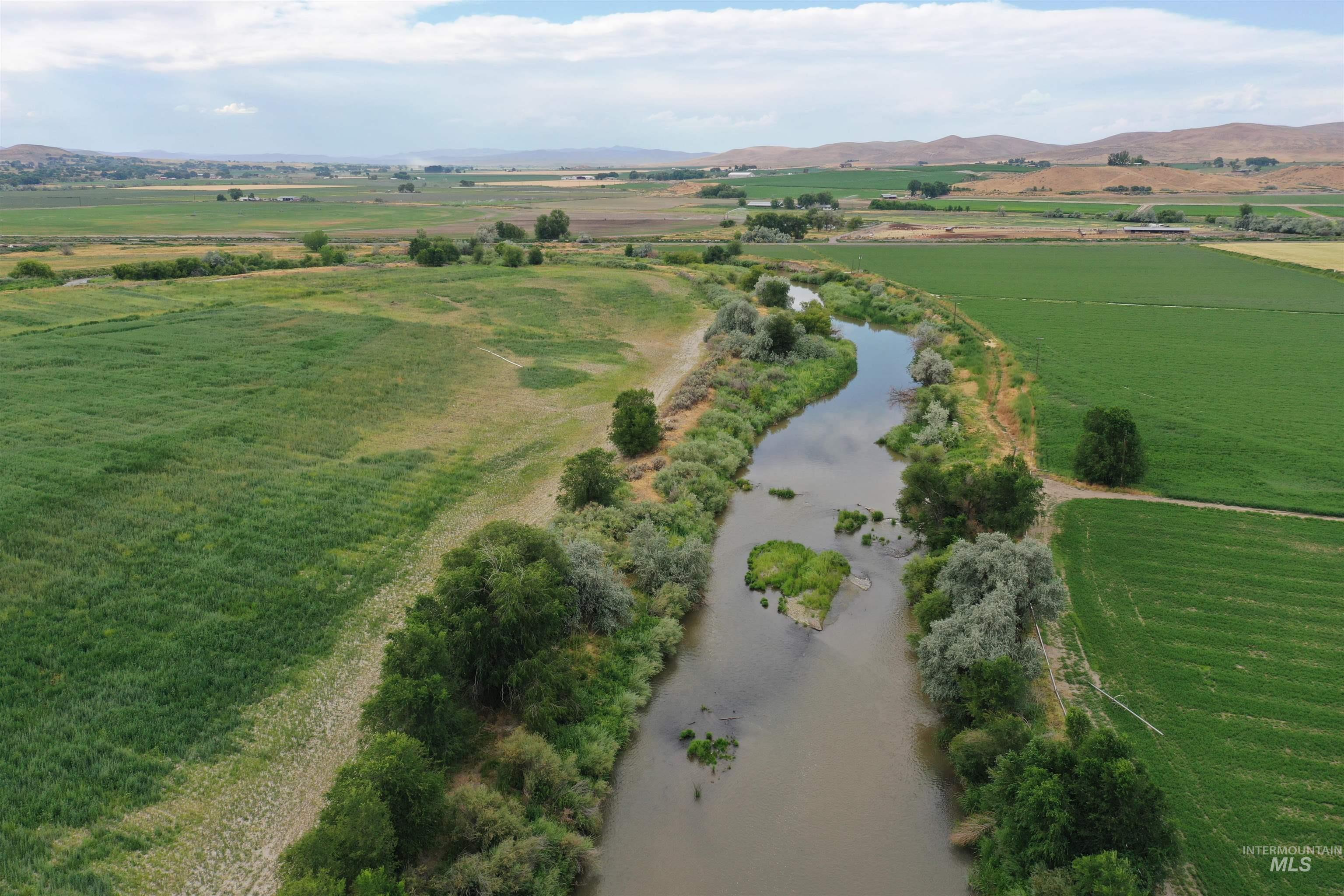 Aerial overview of property's location featuring rural landscape and a water and mountain view
