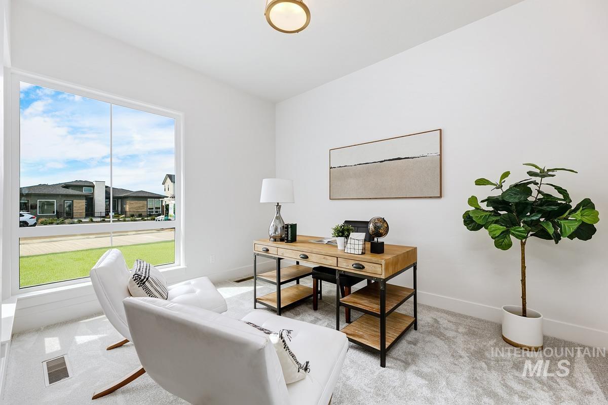 Home office featuring light carpet and baseboards