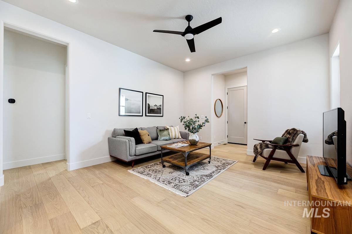 Living area featuring light wood-style flooring, recessed lighting, and a ceiling fan