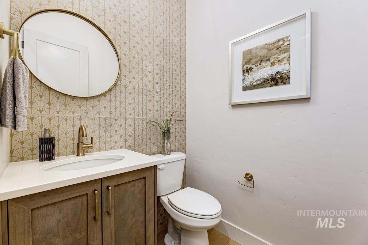 Bathroom with vanity, tile walls, and backsplash