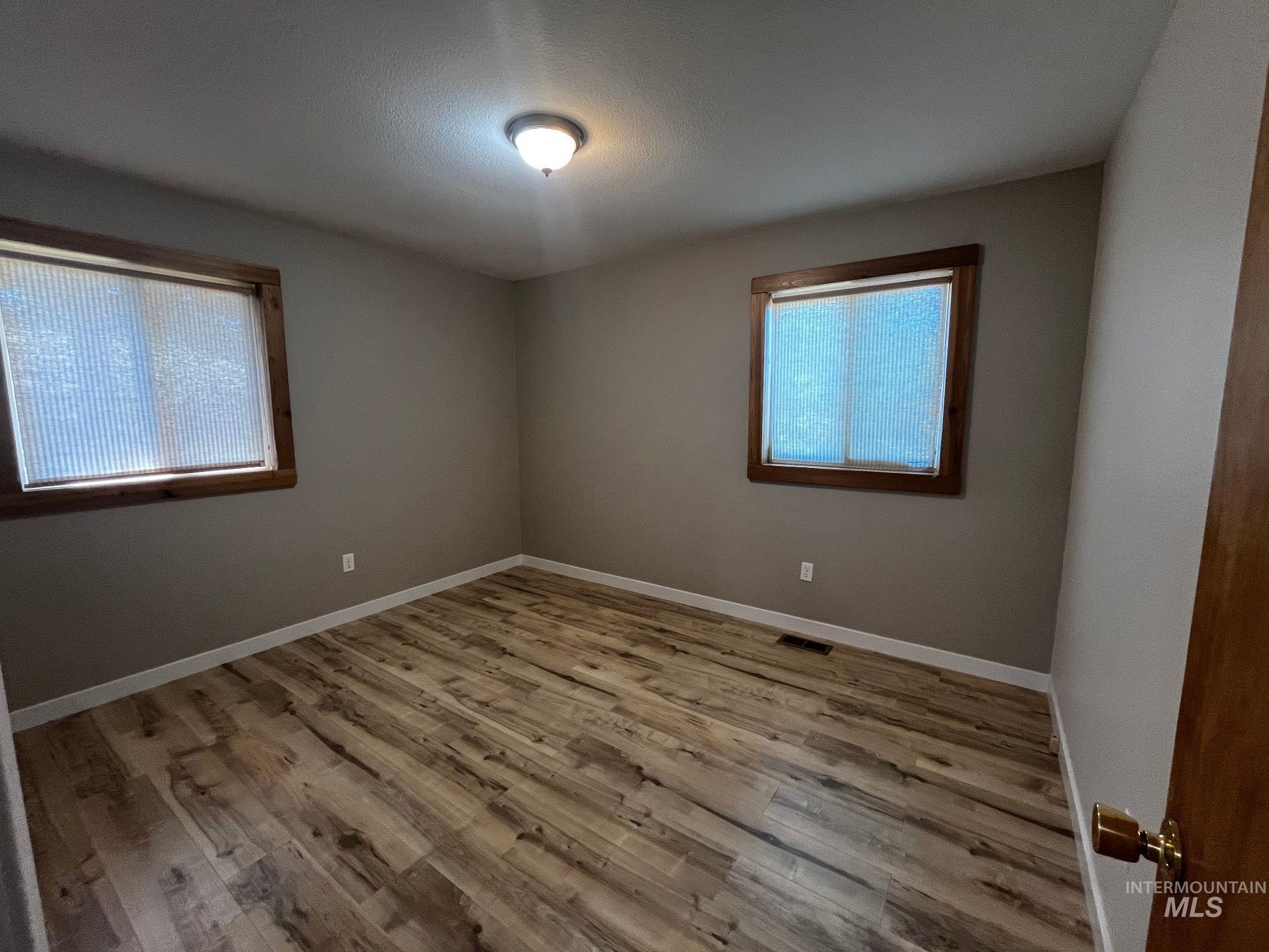 Unfurnished room with wood finished floors