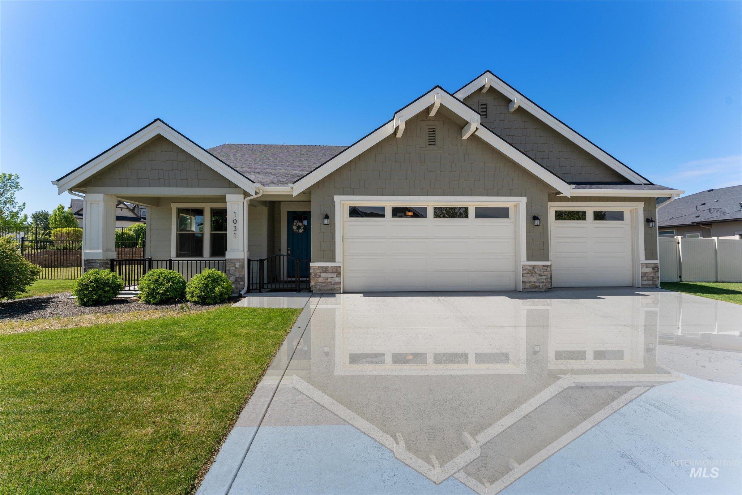 Craftsman-style home with a garage, driveway, stone siding, and a porch
