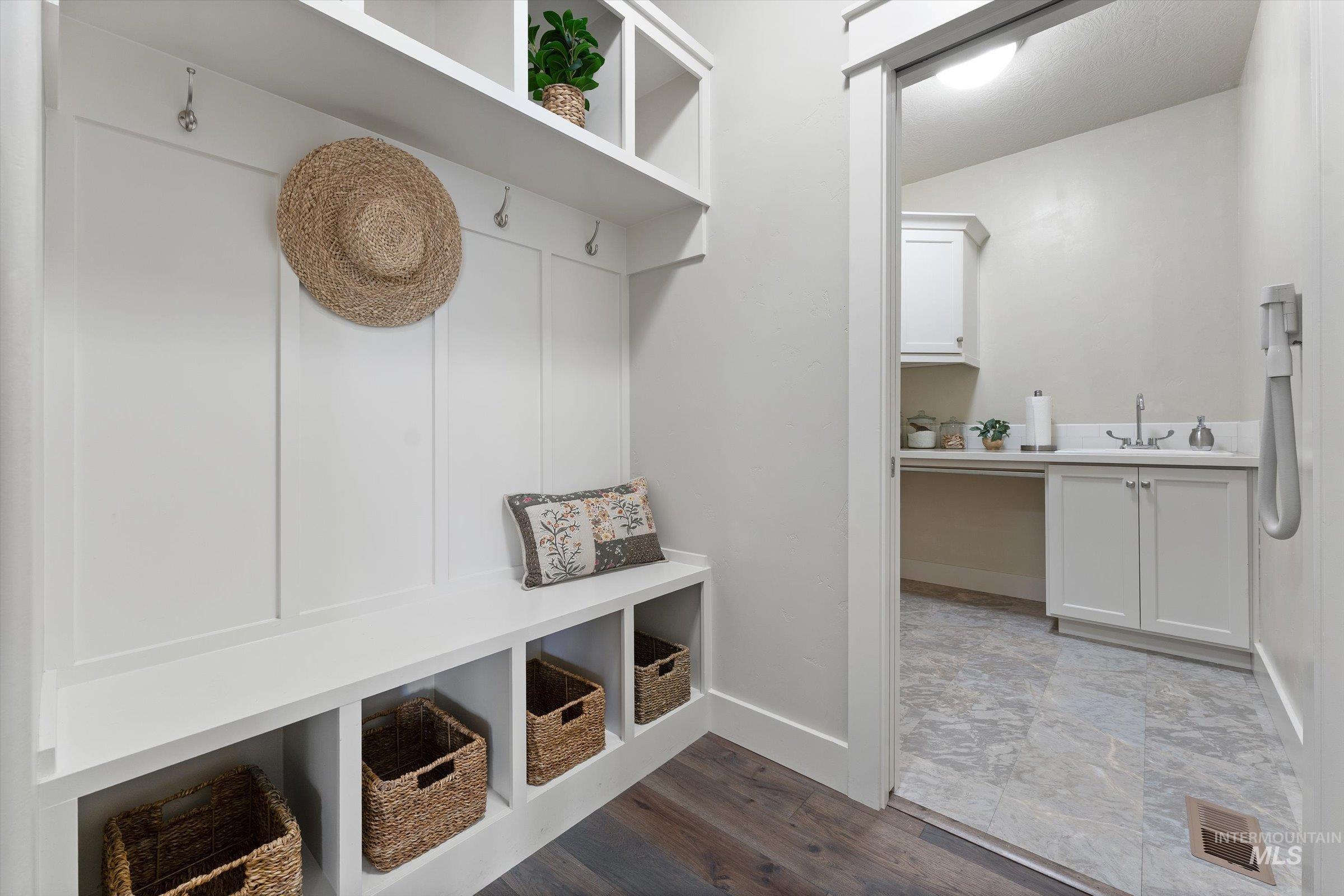 Mudroom with baseboards and dark wood-style floors
