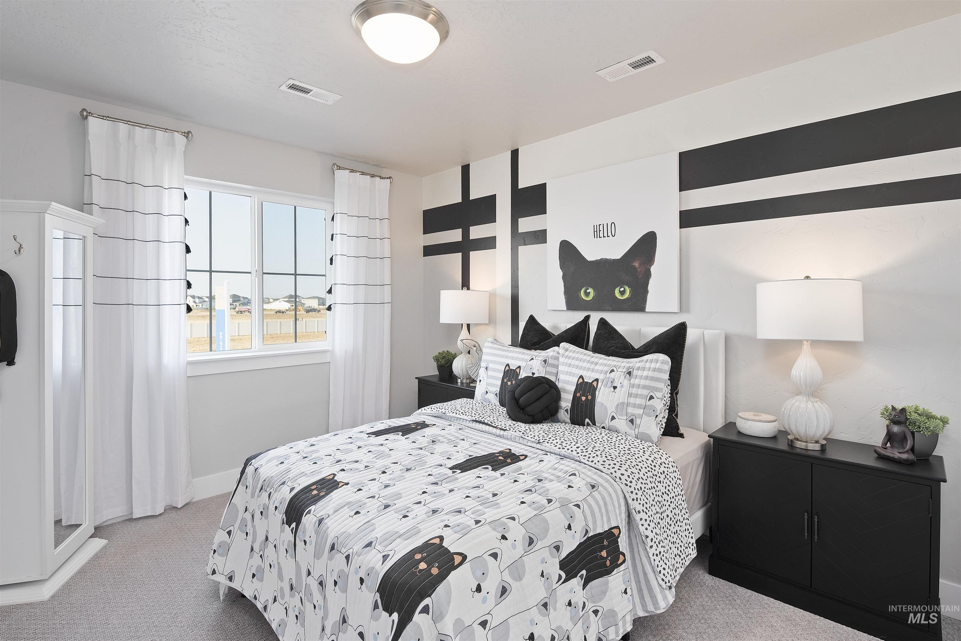 Bedroom with light colored carpet and baseboards