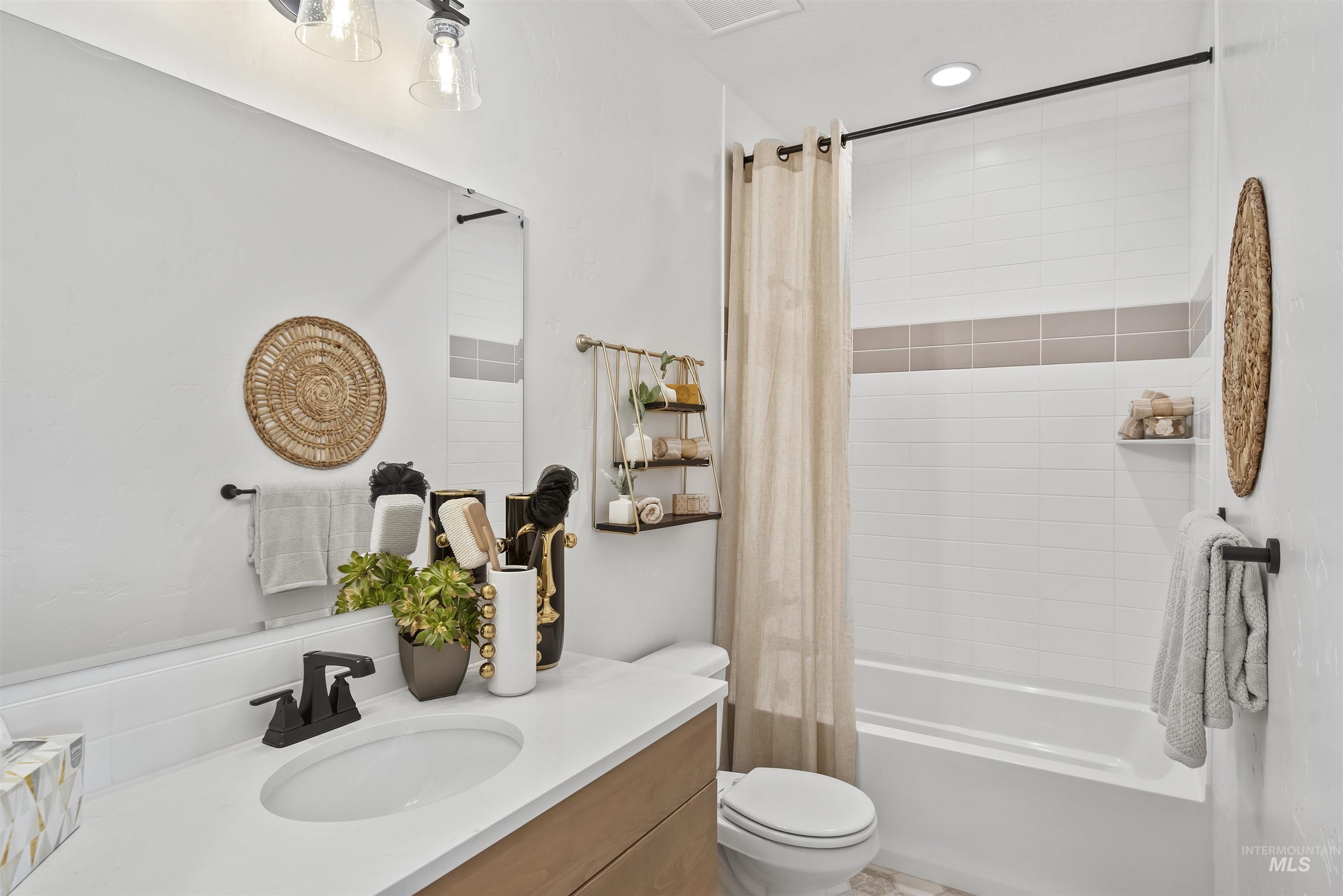 Full bathroom with shower / bath combo, vanity, and recessed lighting